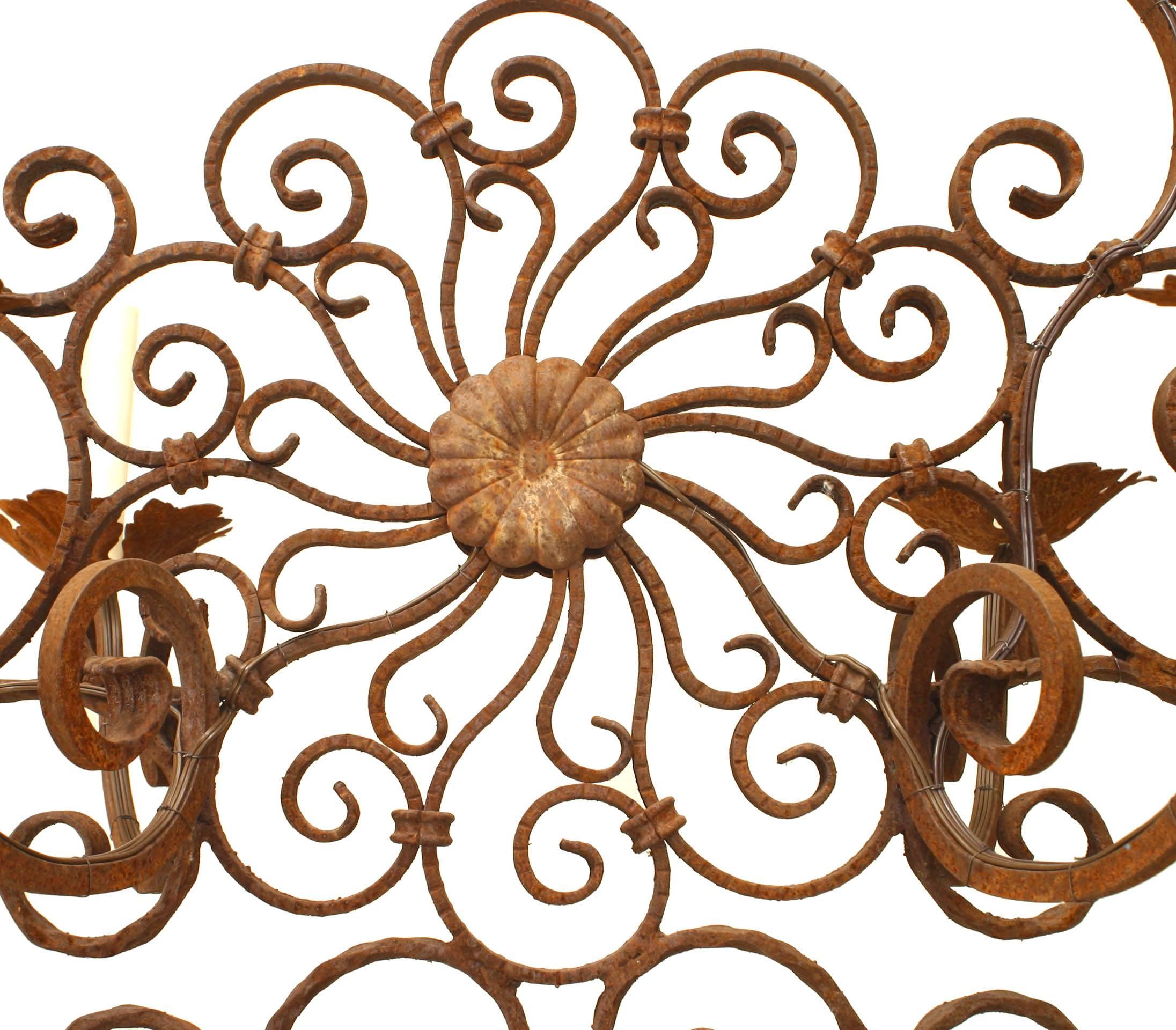 Italian Renaissance style (19th-20th century) wrought iron chandelier with six scroll arm emanating from a filigree oval centre.
 