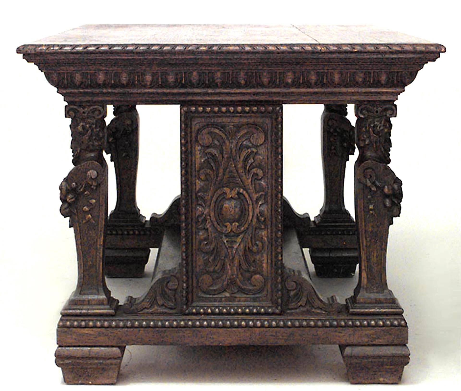 Italian Renaissance style (19th century) oak library style table desk with carved heads on legs and wide stretcher with one drawer on front and back.
    