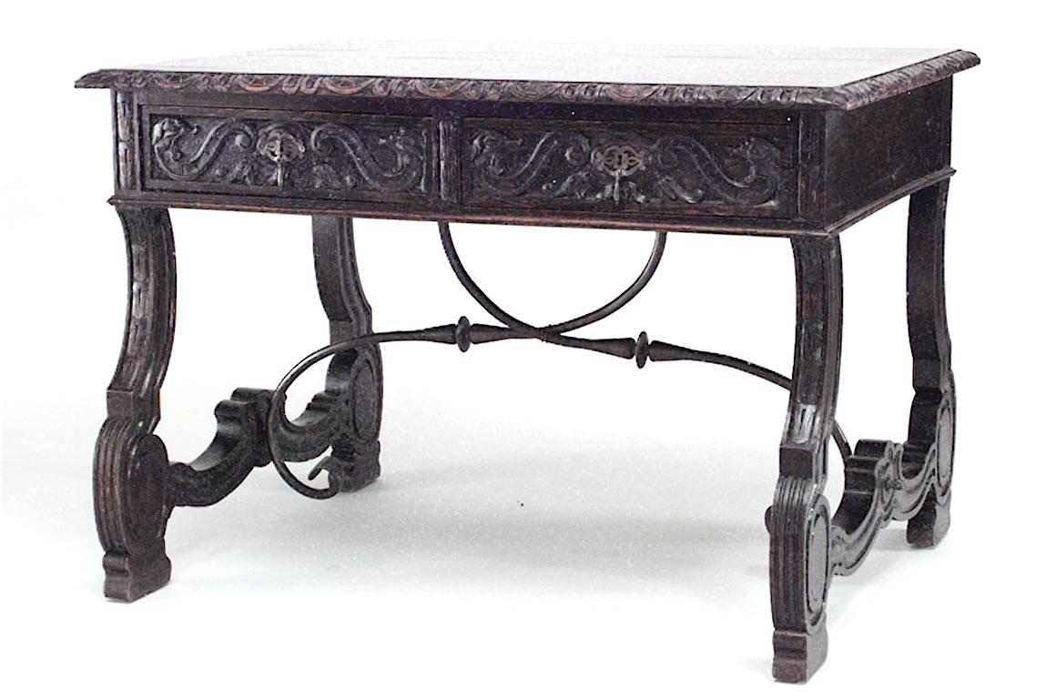 Italian Renaissance style (19th Century) carved oak table desk with double scroll iron stretcher and 2 drawers.
