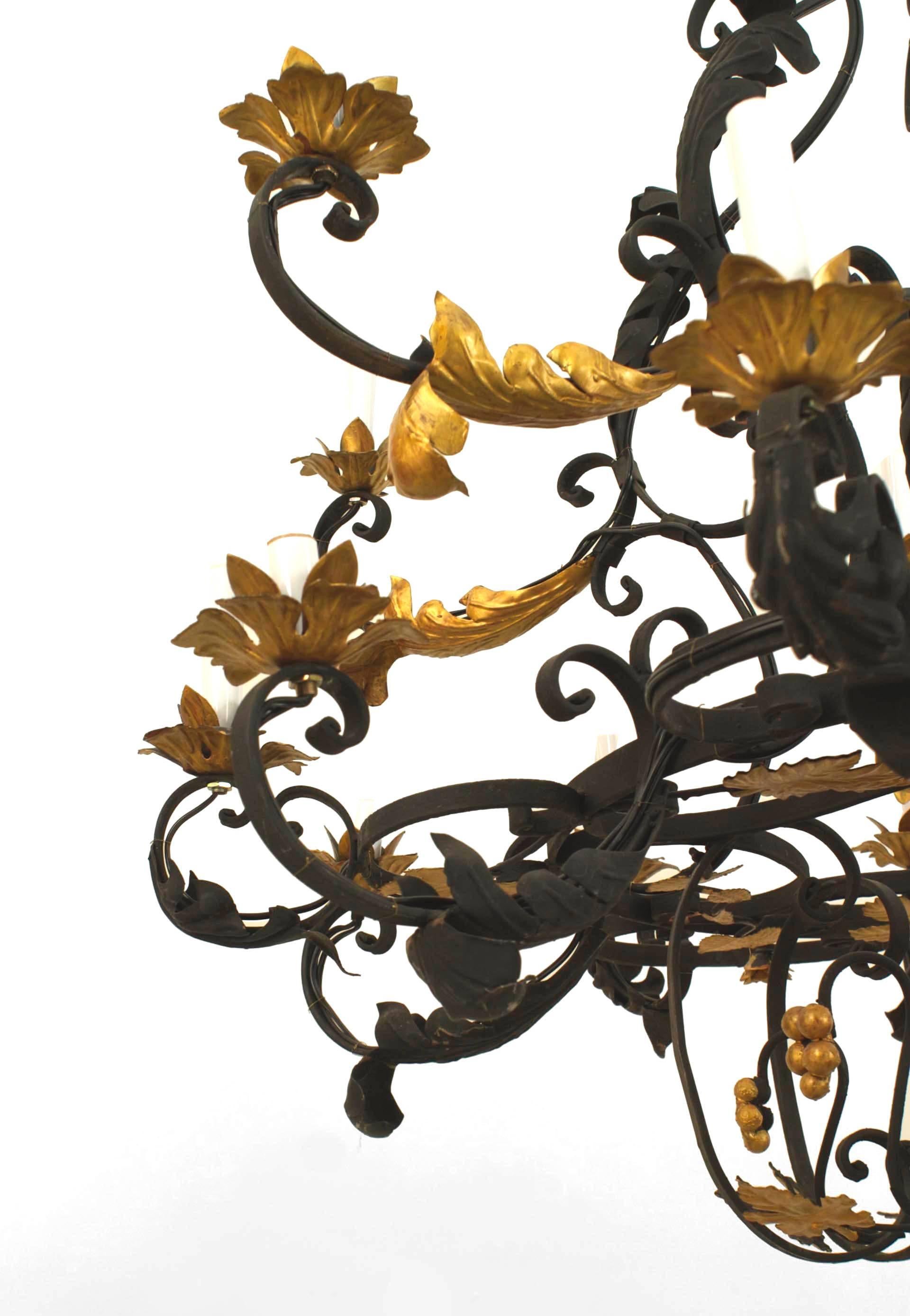 Italian Renaissance style '20th century' black painted 18-light iron chandelier with gilt highlights and a floral and scroll design.
  