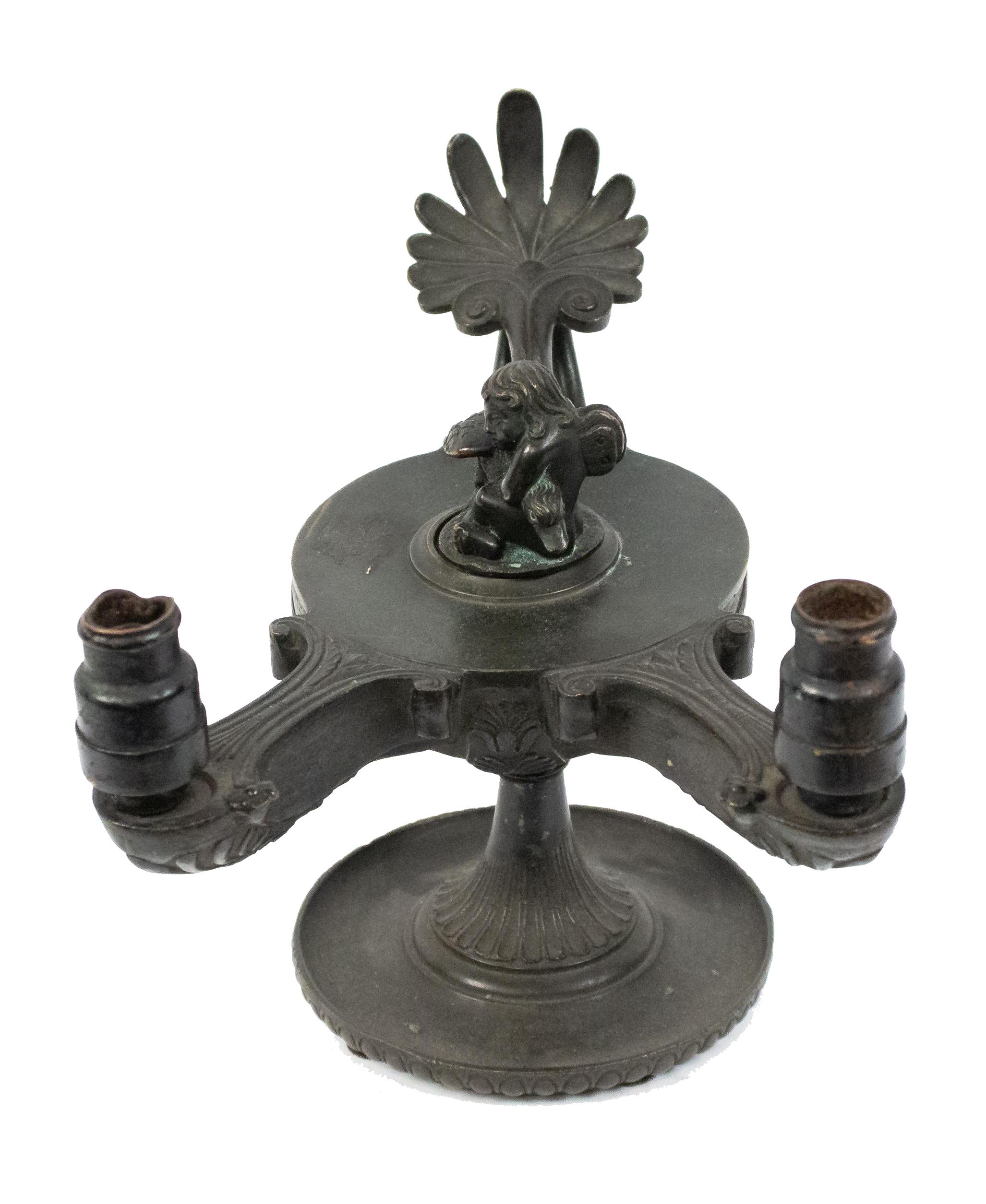 Italian Renaissance style (19th Cent) bronze aladdin lamp with 2 burners and scroll relief with cupid and bird finial.
