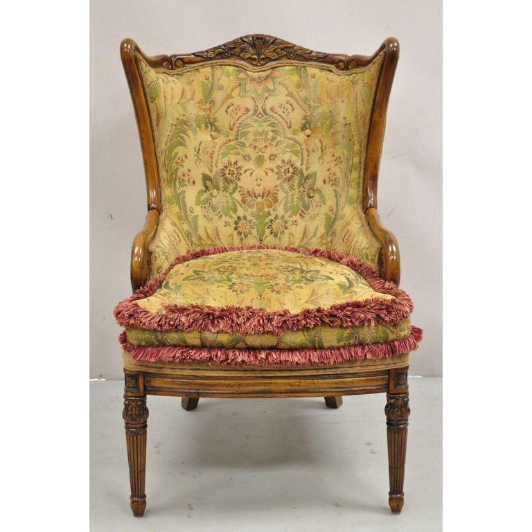 Italian Renaissance Style Carved Wingback Upholstered Armchair. Item features a solid carved wood frame, carved rolled arms, original label. Circa late 20th Century. Measurements: 44