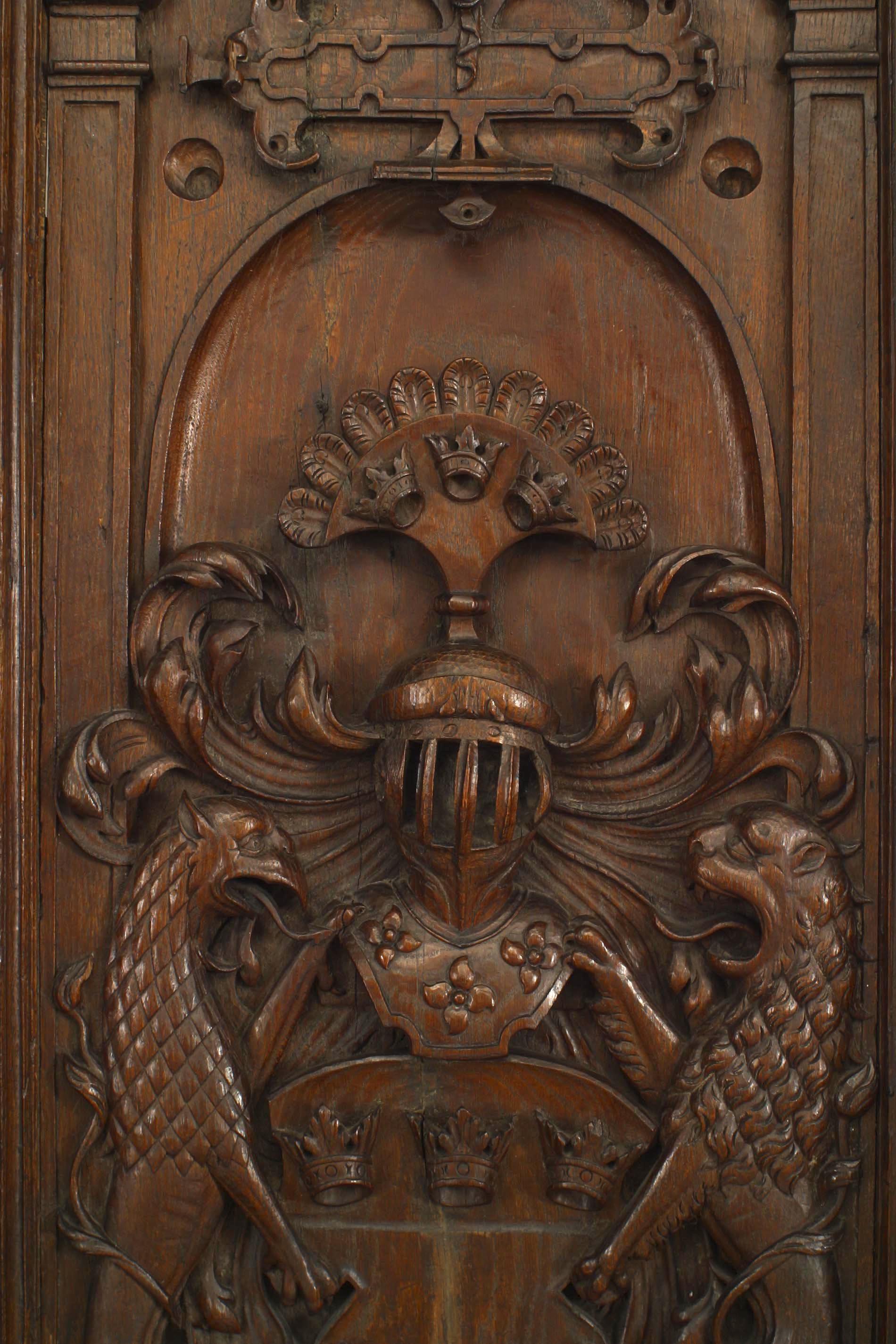 Italian Renaissance style (19th century) carved oak vertical coat of arms wall carving with 2 griffins centering a helmet above 3 crowns.
