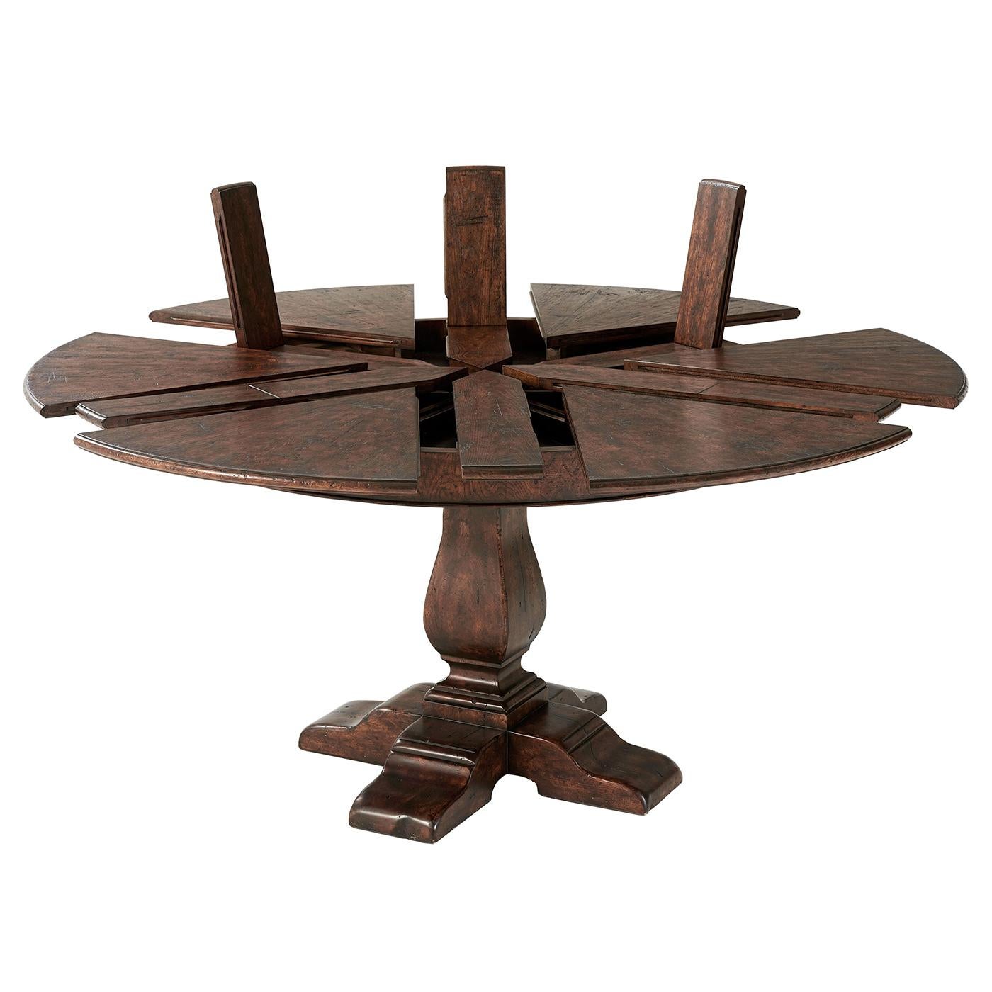 Italian Renaissance style Jupe extension dining table. A reclaimed oak and chestnut burl restored circular extending dining table, the segmented top opening to reveal six self-storing fold out leaves above a plain frieze, on a vase column support