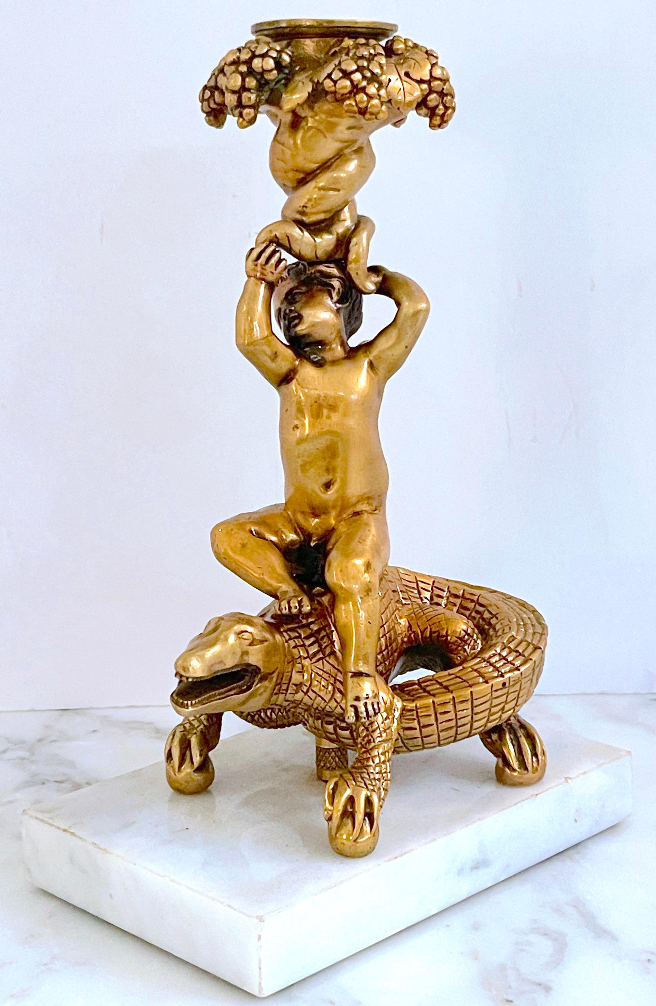 Italian Renaissance Style Gilt Bronze & Marble Putti on Crocodile Candlestick  
Italy, Late 19th Century 

Behold the elegance of this Italian Renaissance style gilt bronze & marble putti on crocodile candlestick from the late 19th century. Standing