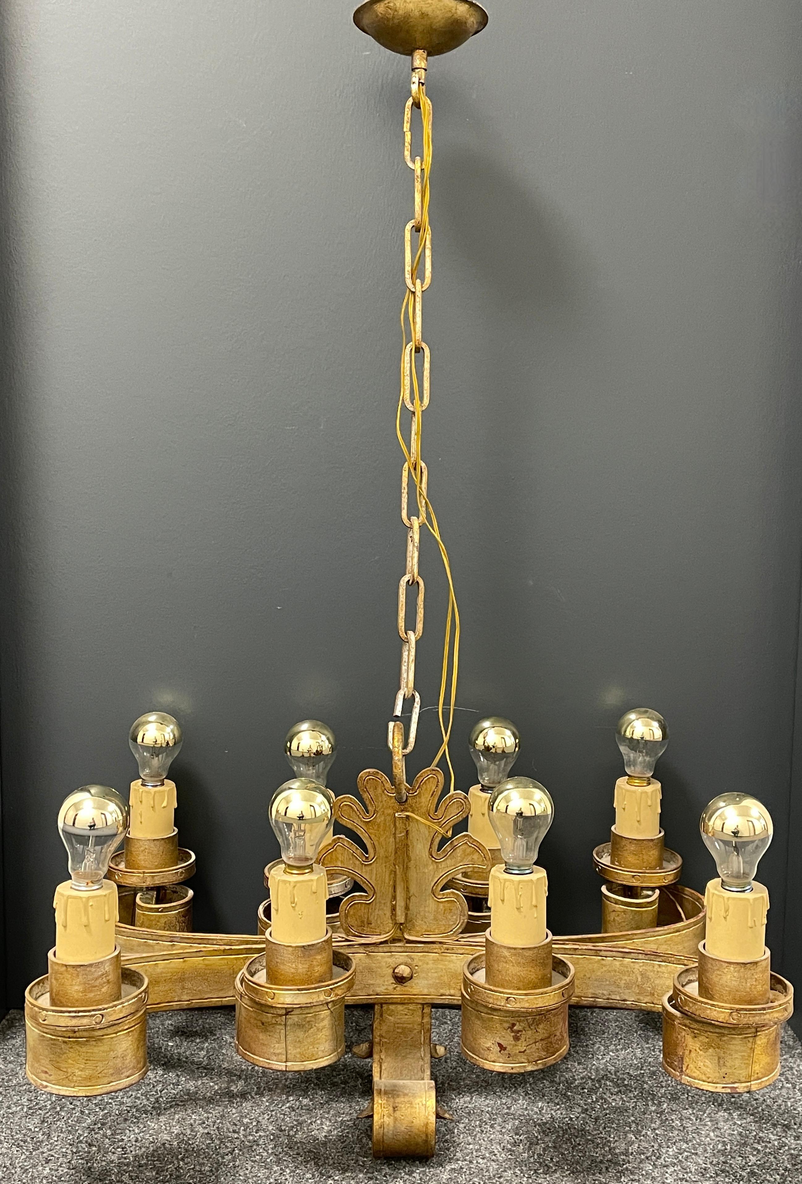 Add a touch of opulence to your home with this charming chandelier! Perfect gilt Iron Metal to enhance any chic or eclectic home. We'd love to see it hanging in an entry hall or in a Living / Dinning room area. Built in the 1960s, this chandelier