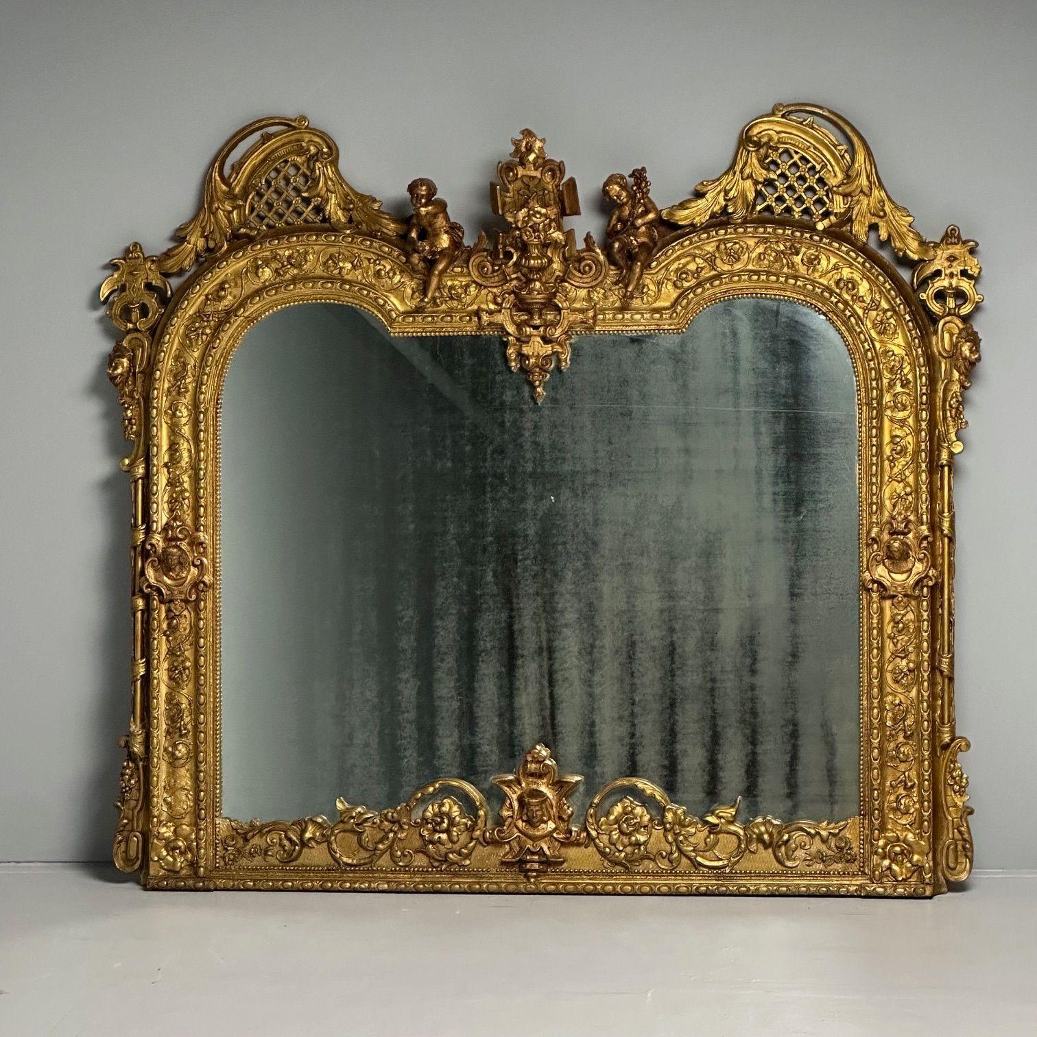 Over the Mantle or Wall Mirror, Oil Gilded, Italian Renaissance Style, Heavily Carved

A once in a lifetime opportunity to acquire a monumental wall, console or over the mantle mirror. This late 19th century mirror having a later mirror center place