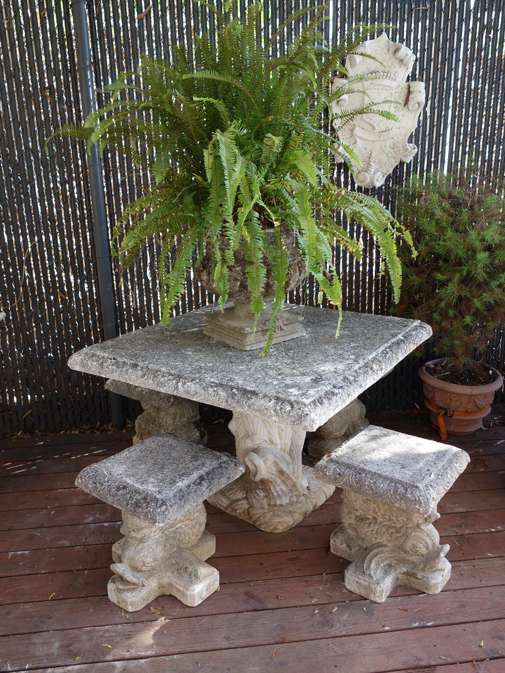 From an enchanted era - a lovely Italian Garden table & four seat set - hand made from a local stone & cement cast mixture in Como. 

Renaissance style Venetian grotto dolphins support the table top and seats. Edges softened with time and cultured