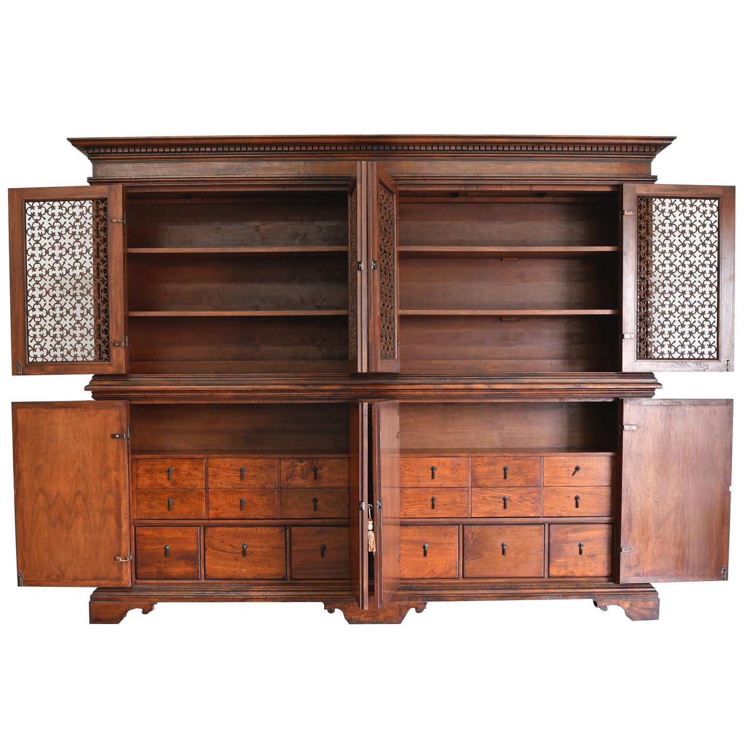 A magnificent Italian Renaissance-style bookcase cabinet that was faithfully copied from an original 17th century Italian Renaissance Tuscan Archival. The upper bookcase has inset hand forged iron quatrefoil panels in its four doors with interior