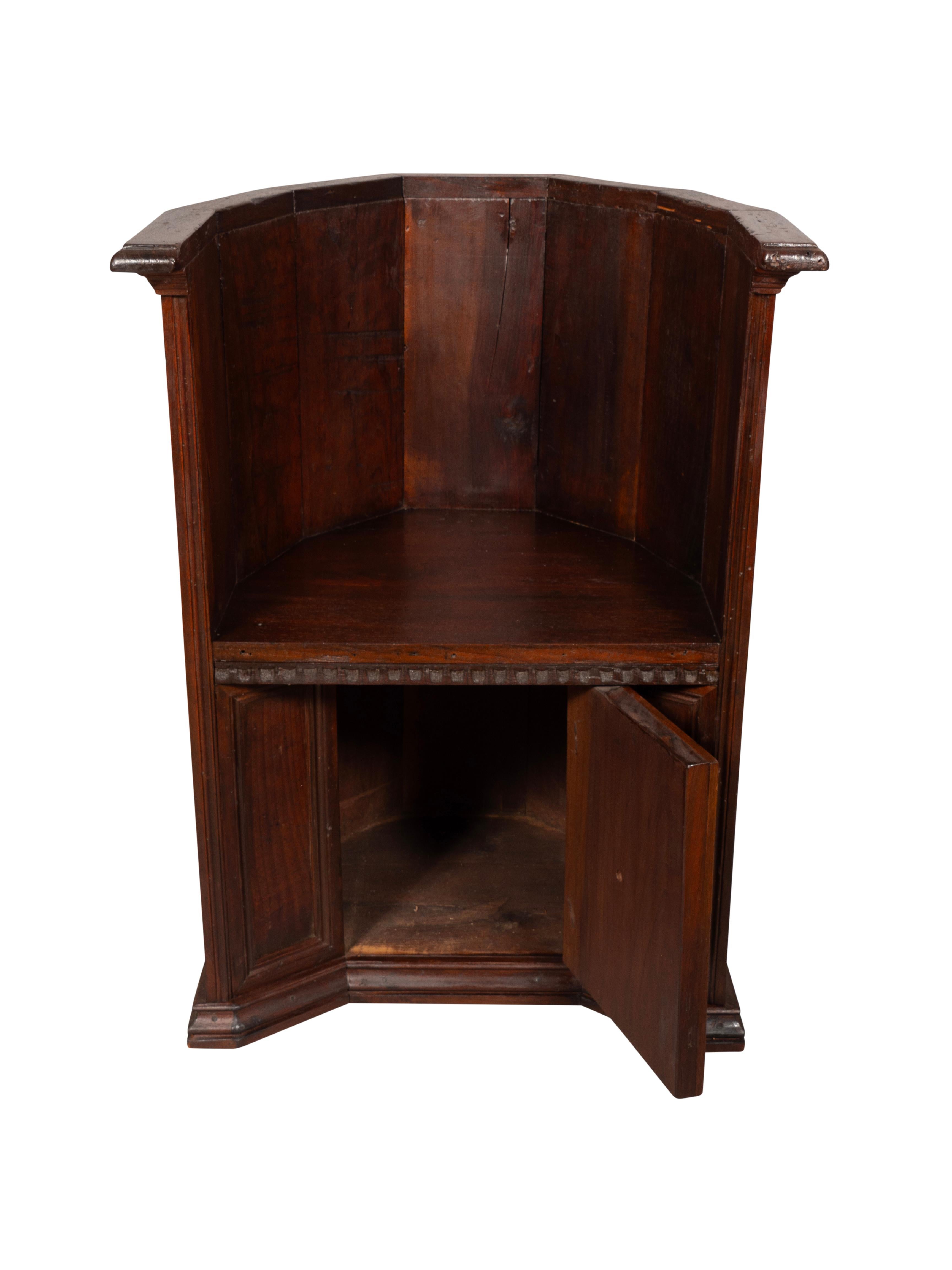 Barrel form with paneled back. The seat over a door with wood knob handle.