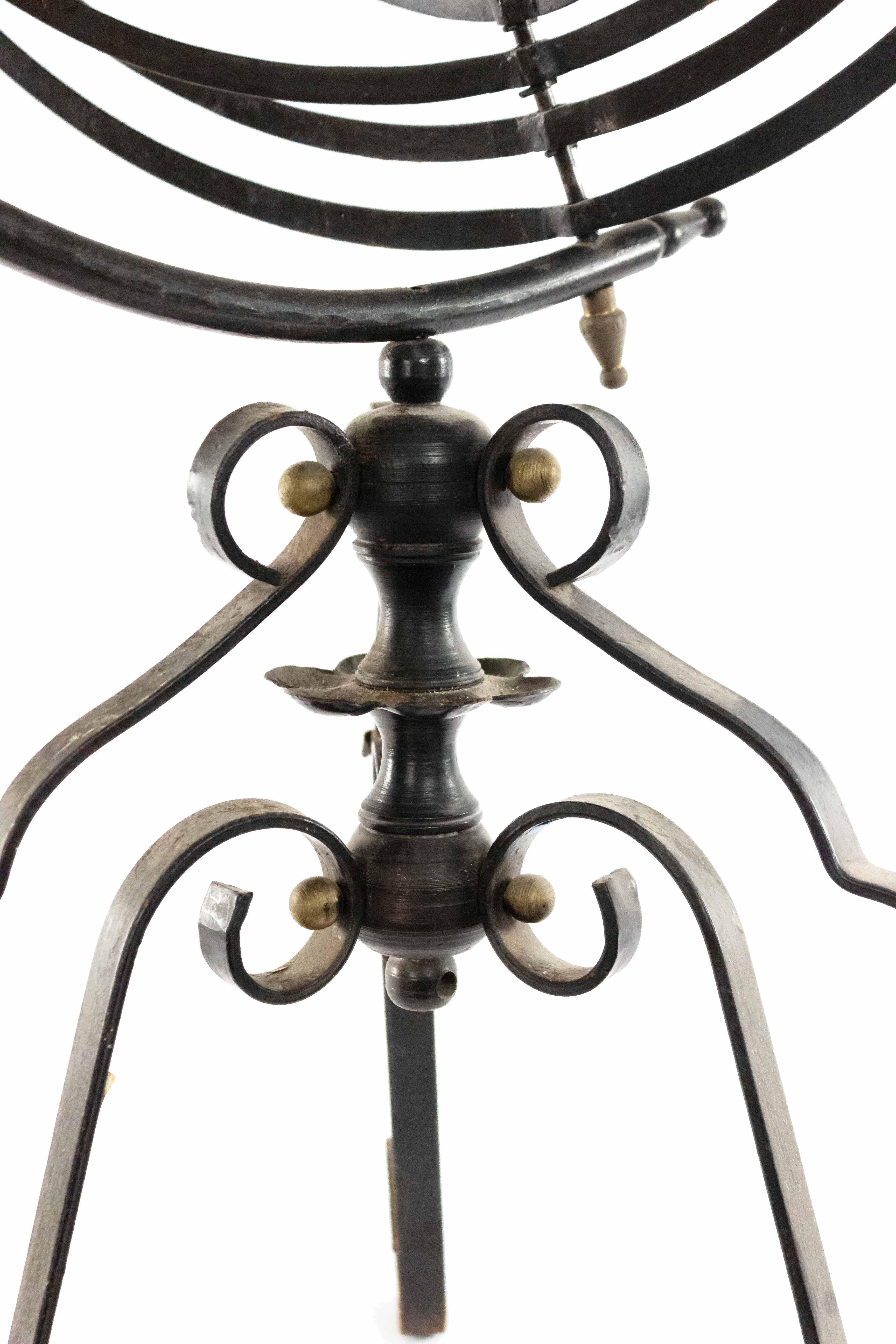 Italian Renaissance style wrought iron floor standing armillary globe supported on a 3 scroll leg base.
 