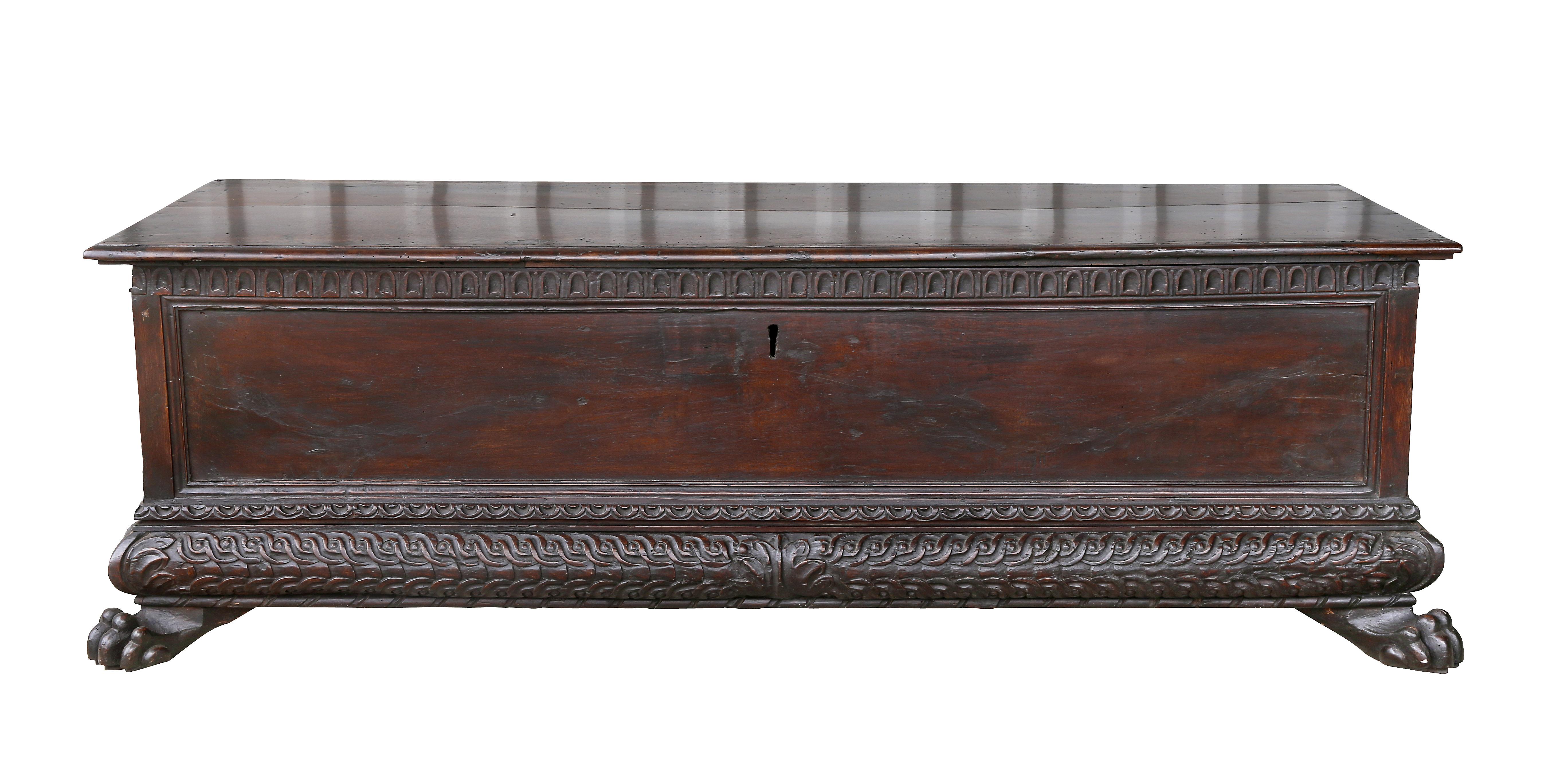 Rectangular hinged top opening to compartment over a conforming case with carved arched fluted carving, the base with guilloche carving and acanthus leaf carved corners, lions paw feet.