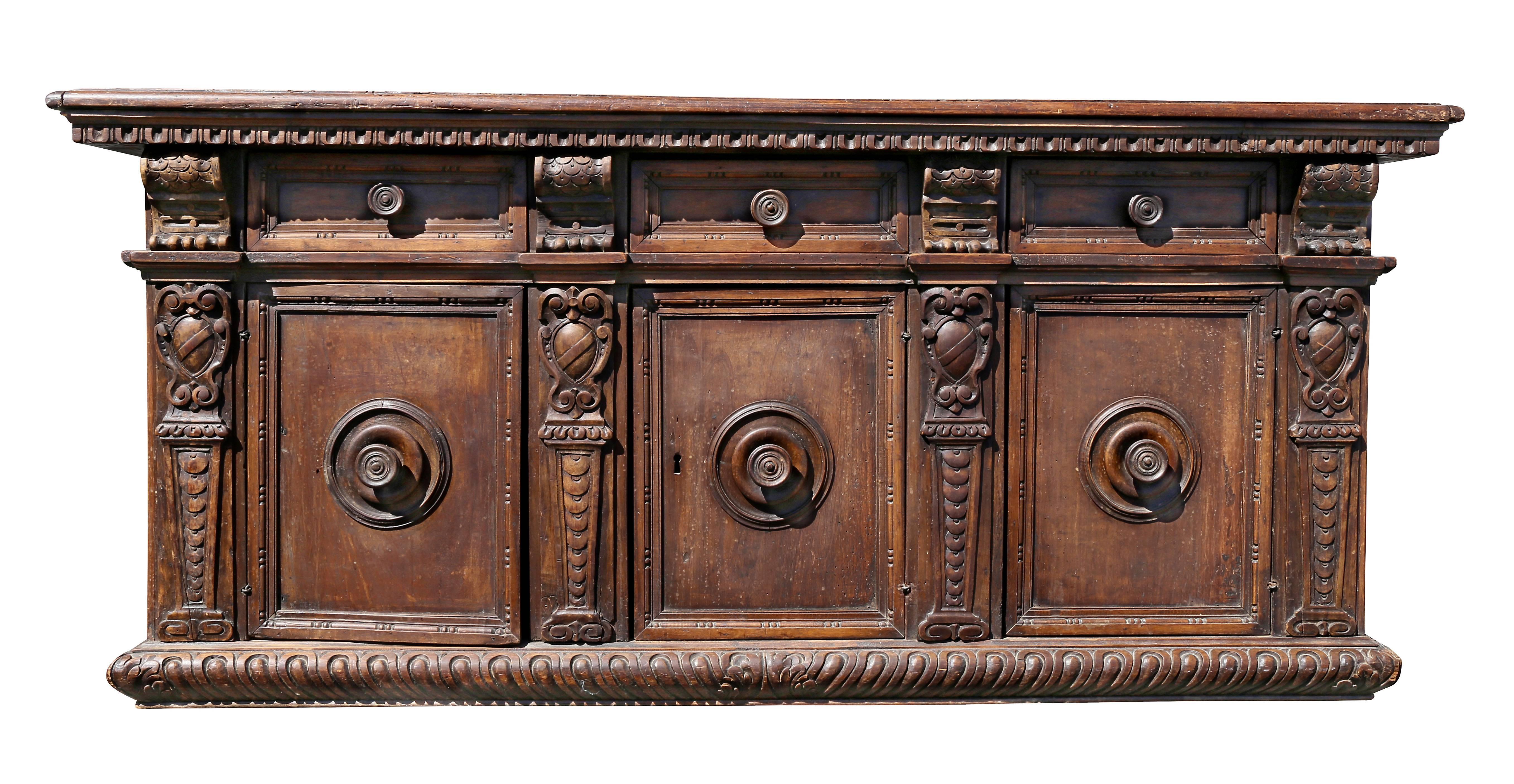 Rectangular top over three drawers flanked by corbels over three drawers flanked by cartouches on a gadrooned base. Lacking its original base.