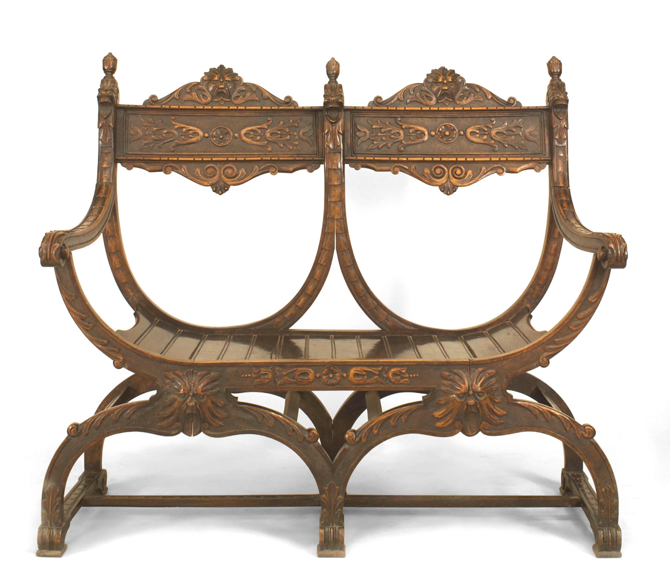 Italian Renaissance style carved walnut Savonarola style loveseat with carved heads, 19th-20th century.