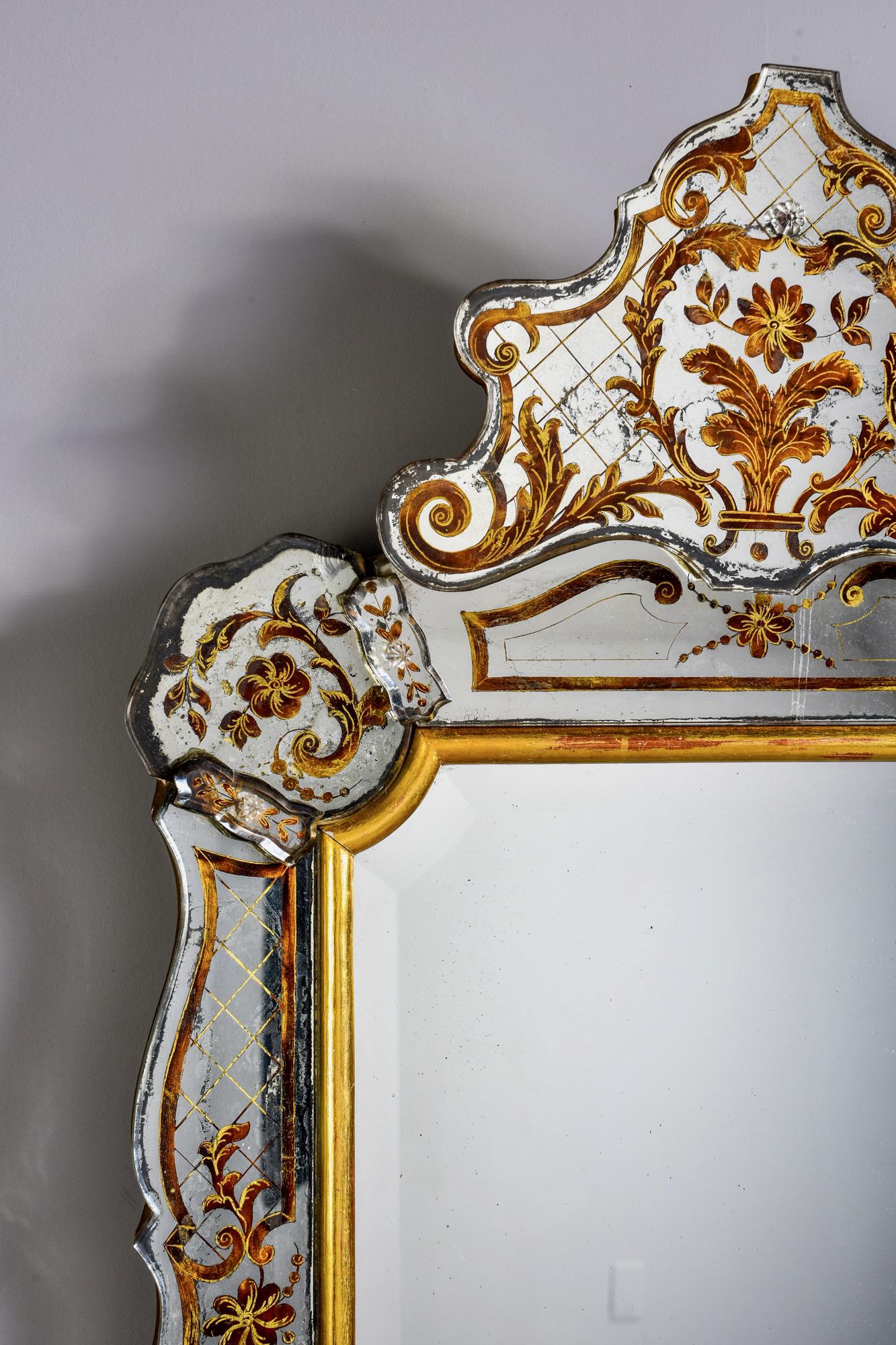 Italian Venetian style crested mirror with reverse gilt painted details, circa 1940s. Unknown maker.