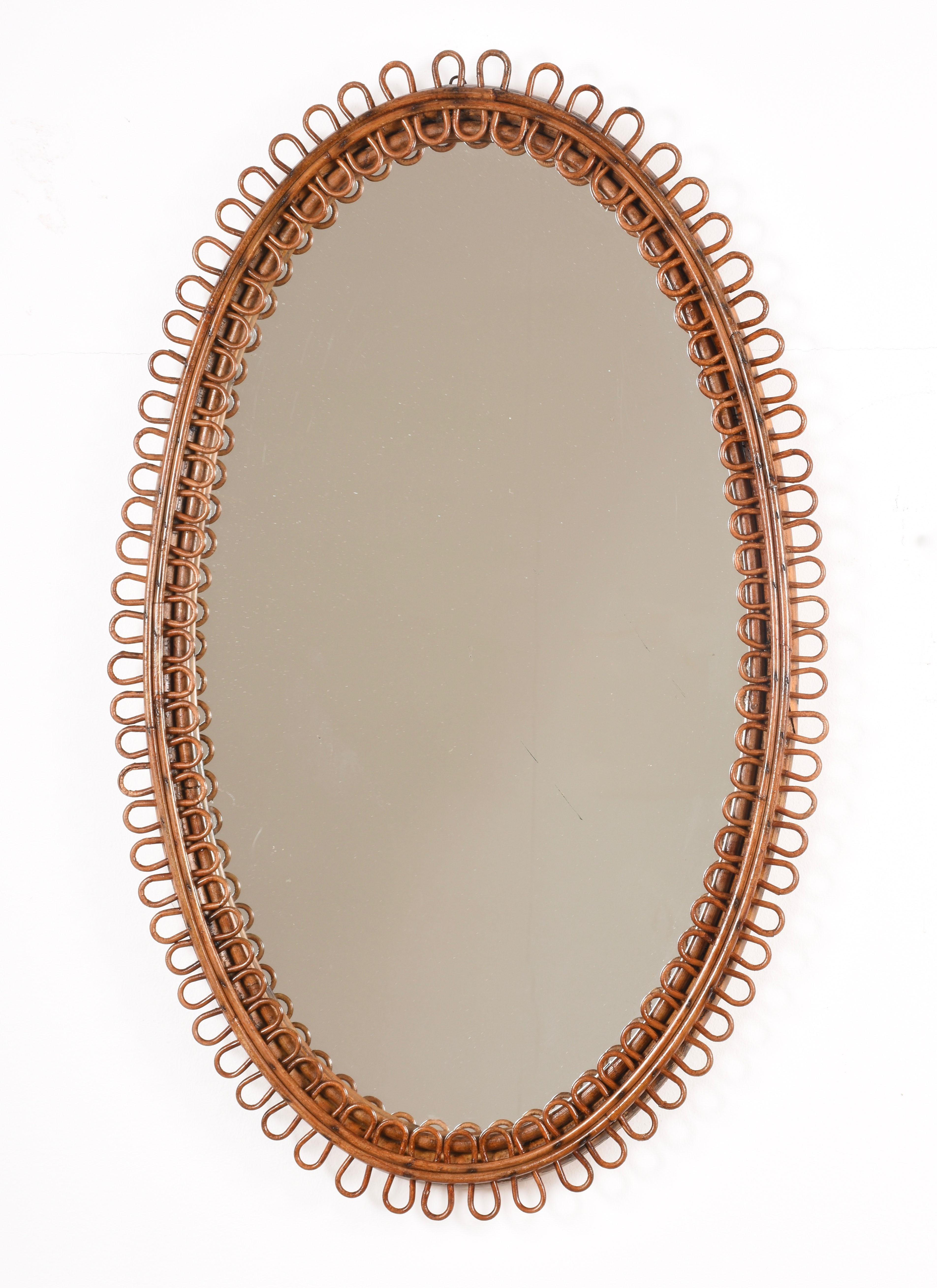 Very decorative oval mirror with curved rattan beams and bamboo frame attributed to Franco Albini, Italy, 1950s. Measurements: 79 x 50 cm. Available other round, oval and teardrop mirrors by Franco Albini with this same design.