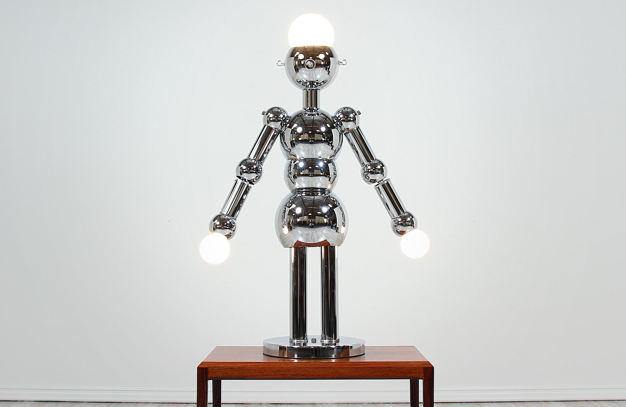 Unique robot lamp designed and manufactured by Torino Lamps Co. in Italy, circa 1970s. This artistic lamp is made of chrome steel that was recently polished. The lamp is turned on/off using the switch that duals as the nose. Three light settings