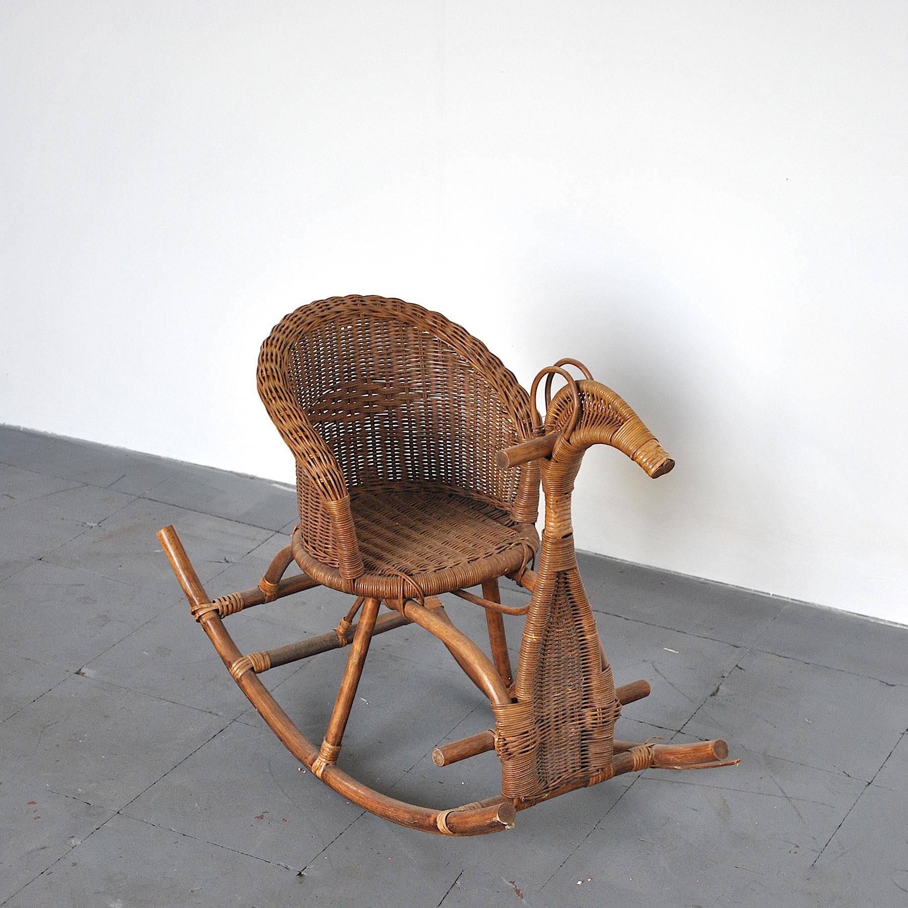 Rocking chair for children in rattan from 50s.