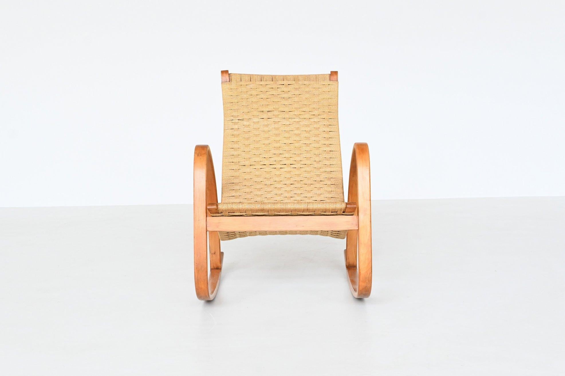 Beautiful shaped Italian rocking chair in the style of Luigi Crassevig or Alvar Aalto, Italy 1960. This very nice sculptural rocking chair has a birch bentwood frame which support a woven paper cord upholstery. The choice of materials, solid wood
