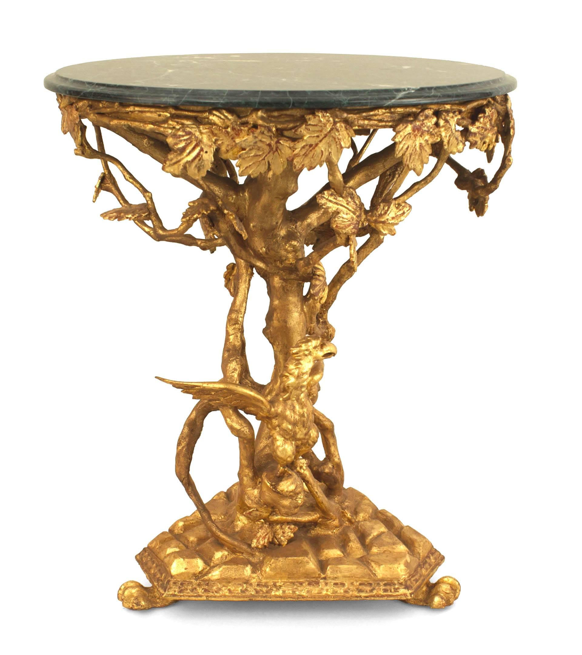 Italian Rococo (18th century) gilt round end table with a floral carved design and eagle figure resting on a triangular base with an apron supporting a round green marble top.
   