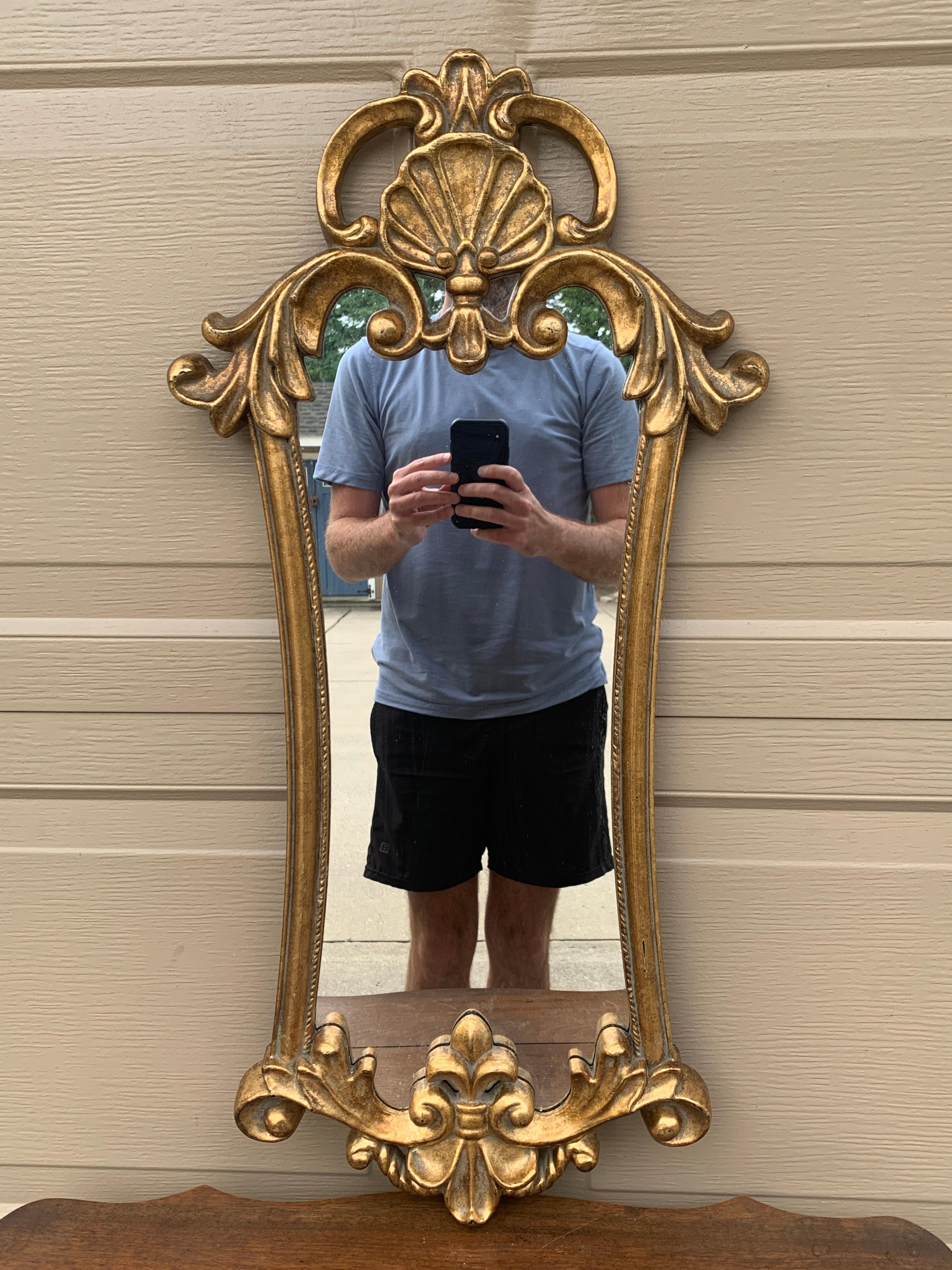 A gorgeous Italian Rococo Baroque style gold cast resin framed mirror

USA, Circa 1960s

Measures: 15.5