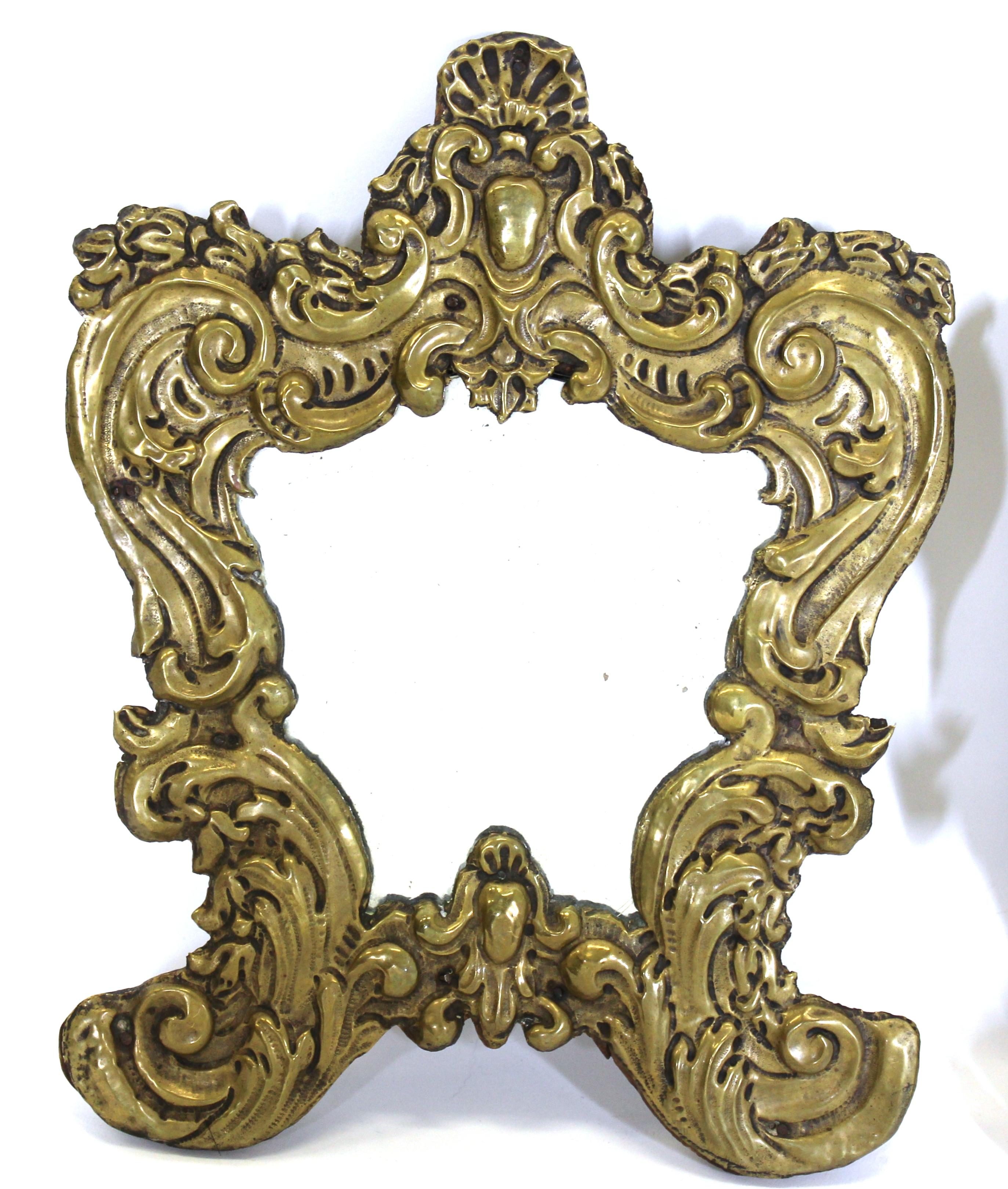 Italian Rococo pair of diminutive mirrors with repousse brass mounted on carved and painted wood. Made in the late 18th century.