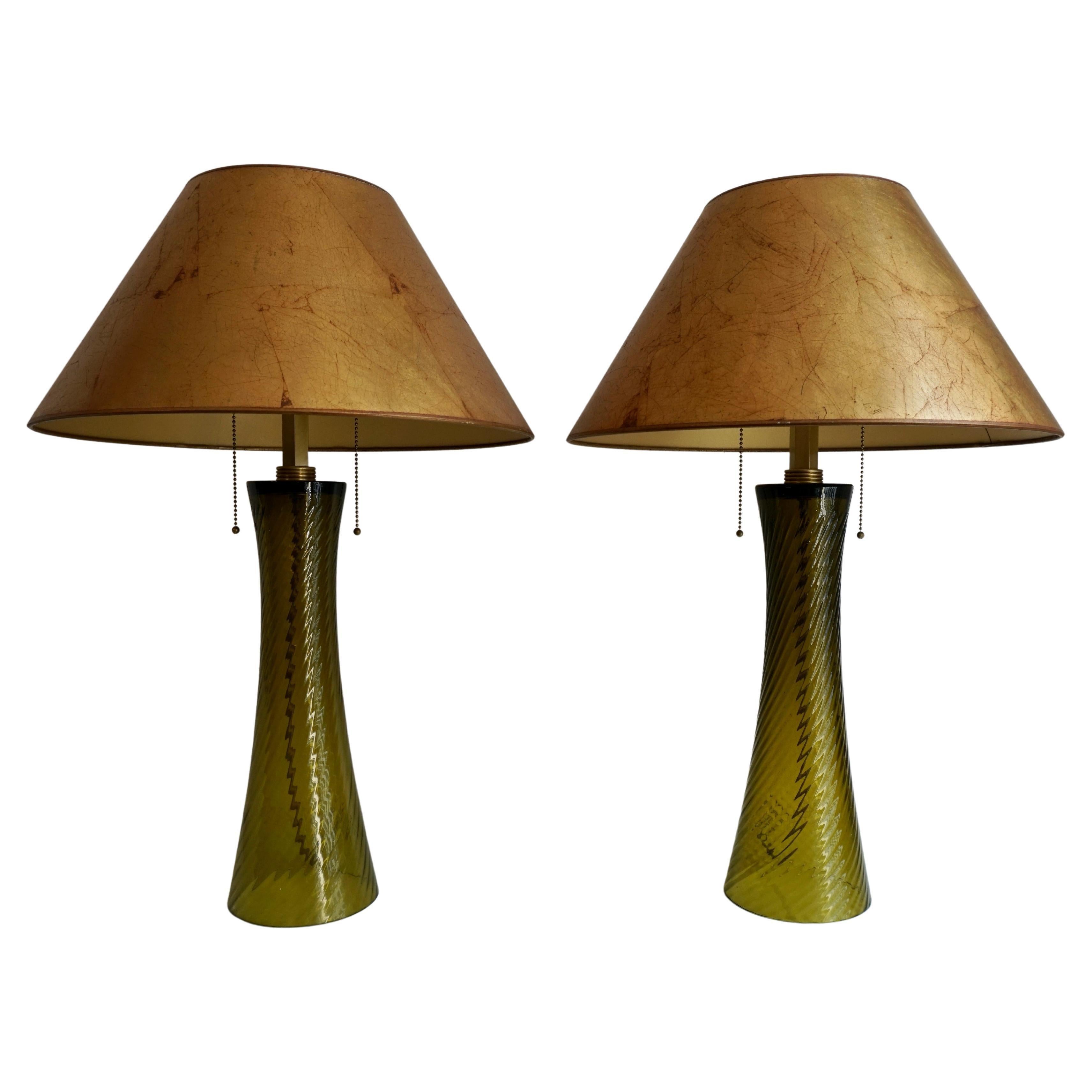 Two beautiful elegant green colored glass lamps with the original patinated gold colored shade.
Signed with the monogram J.H.

Height 28.7