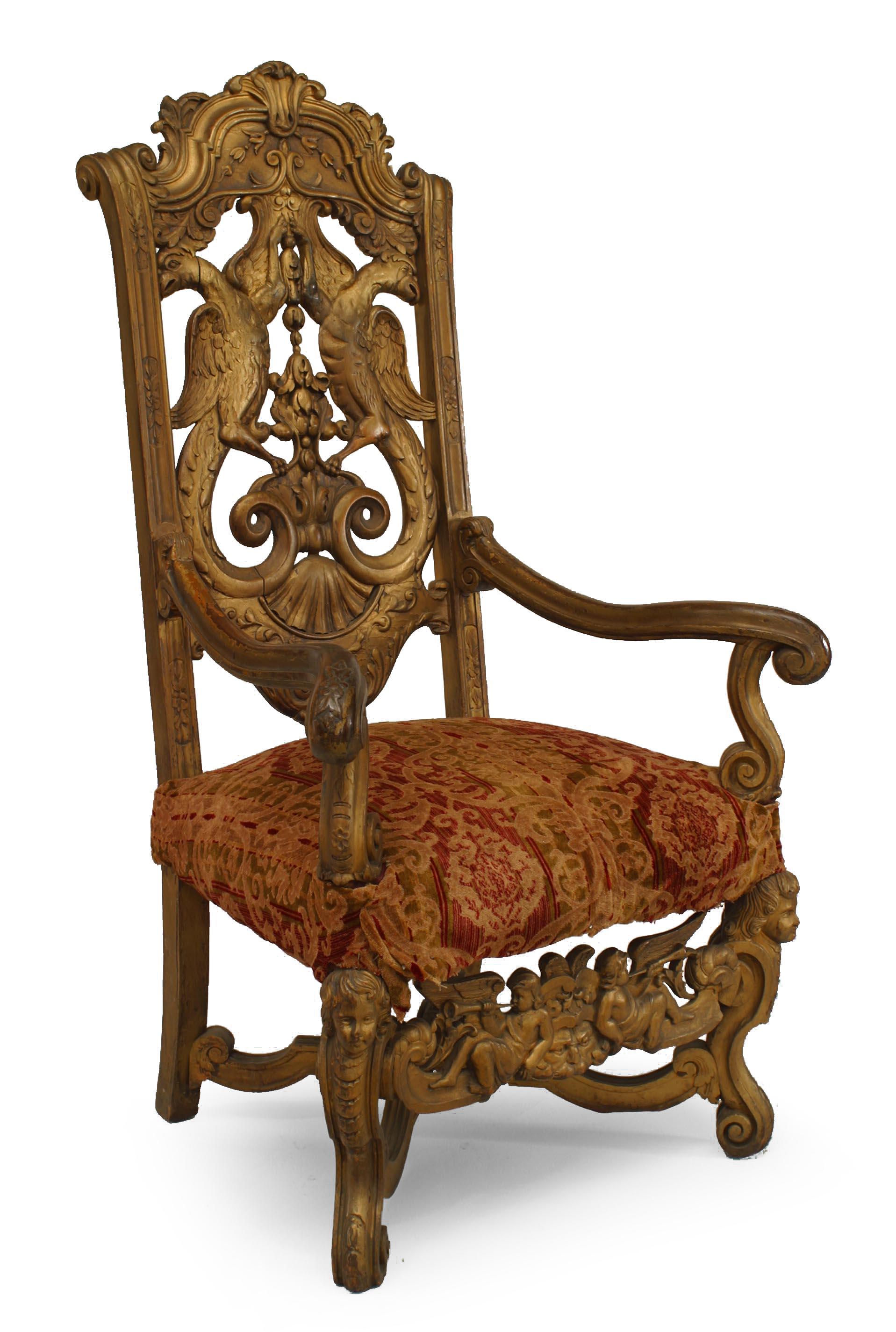 Pair of Italian Rococo style gilt high back carved eagle back armchairs with cupid stretcher and upholstered seat, 19th-20th century.
