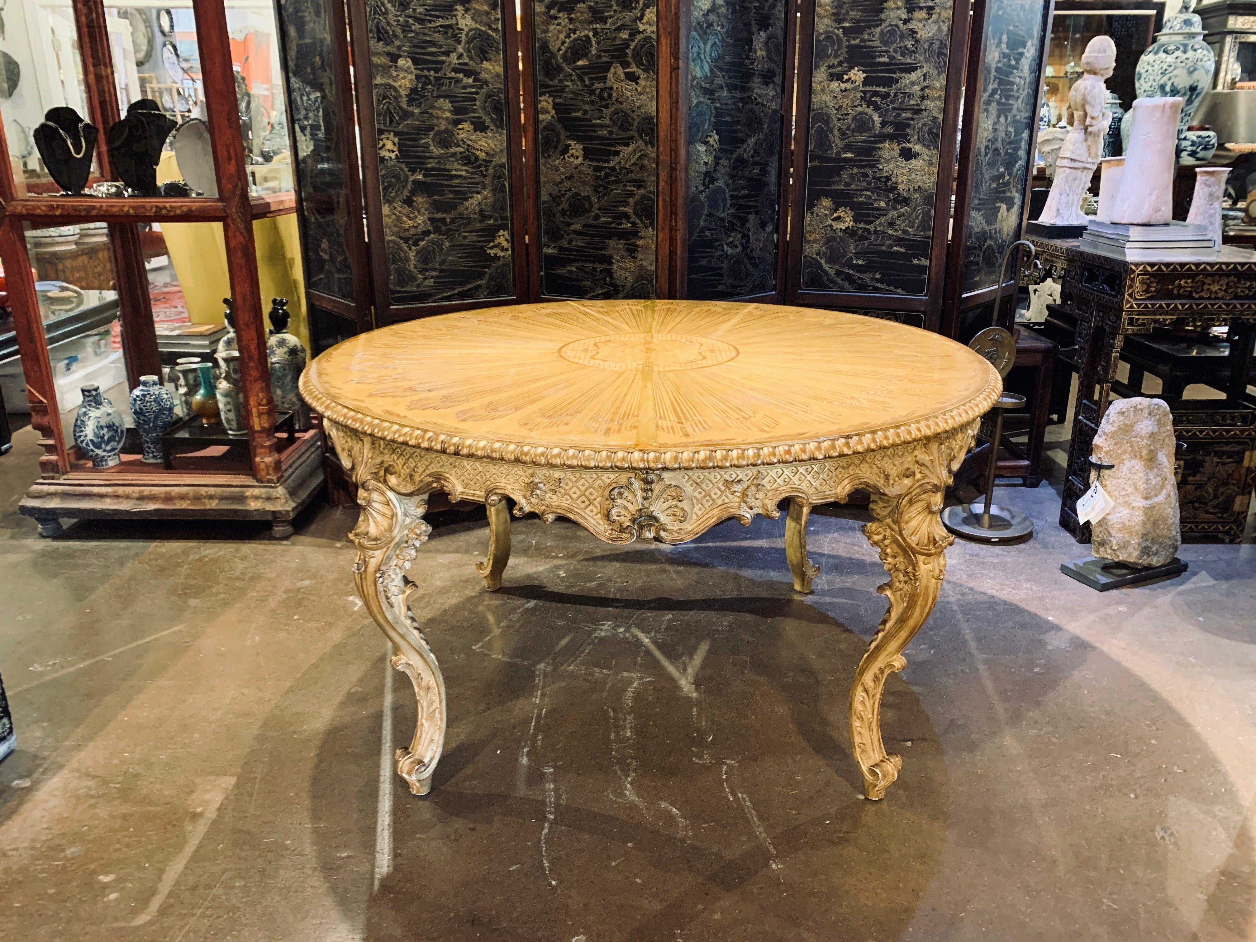 An exquisite, richly gilt Italian carved limewood round center table, late 18th century, probably Naples, Italy. 

The impressive round center table of a restrained carved Rococo design, with four cabriole legs, a shaped apron, and caved round
