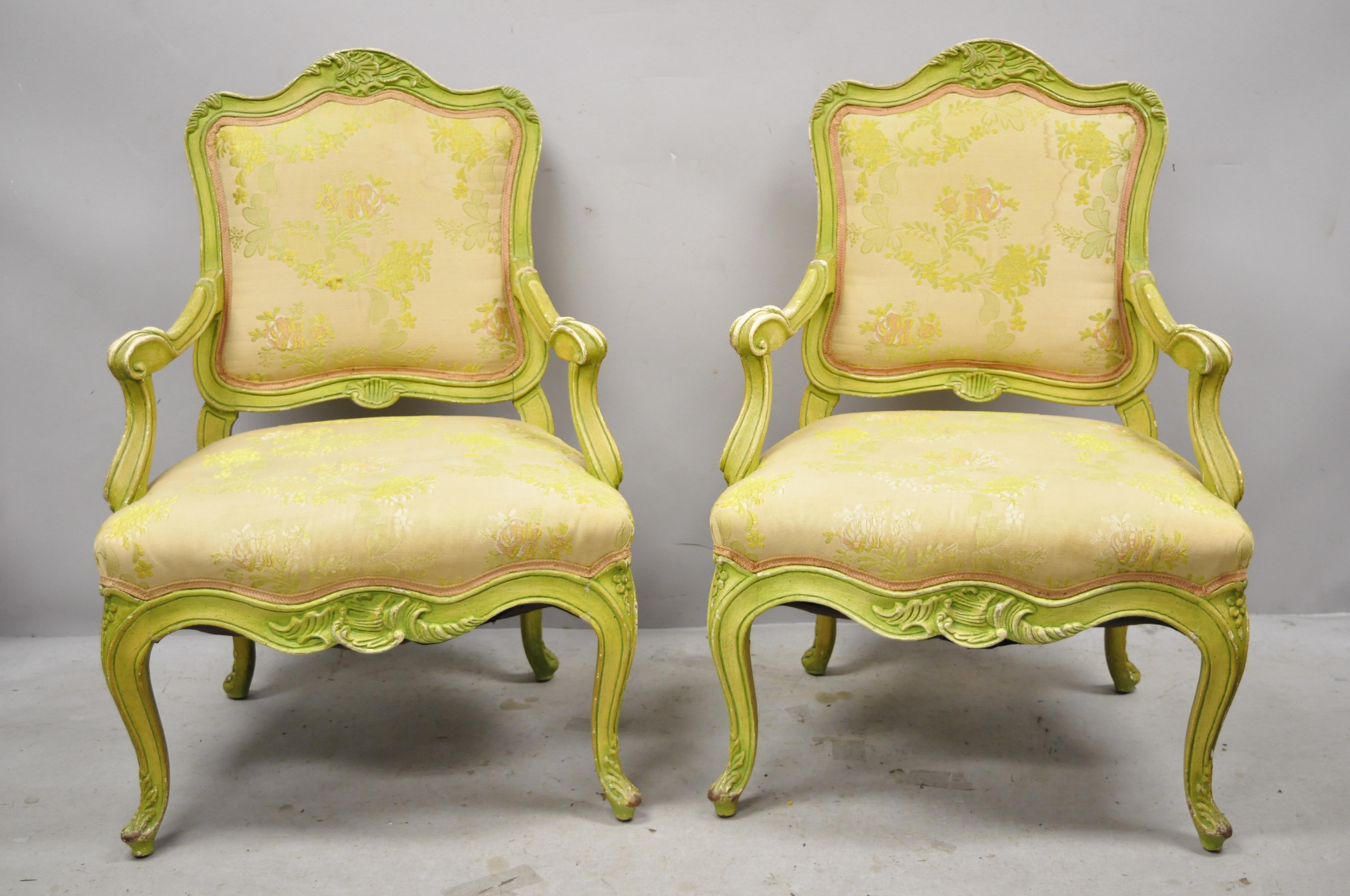 Vintage Italian Rococo Hollywood Regency green painted fireside lounge armchairs, a pair. Item features distressed green painted finish, solid wood frame, nicely carved details, very nice vintage pair, great style and form, circa mid-20th century.