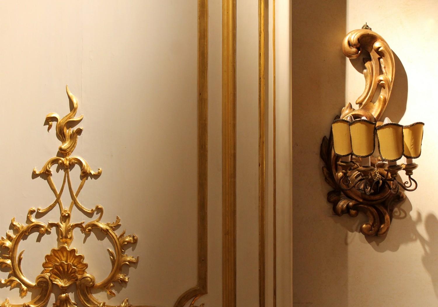 Intricately hand carved and pierced these antique Italian 19th century Rococo Revival Louis XVI style scrolled giltwood wall light sconces are a wonderful example of Tuscan craftsmanship in the art of wood carving and gilding and wrought