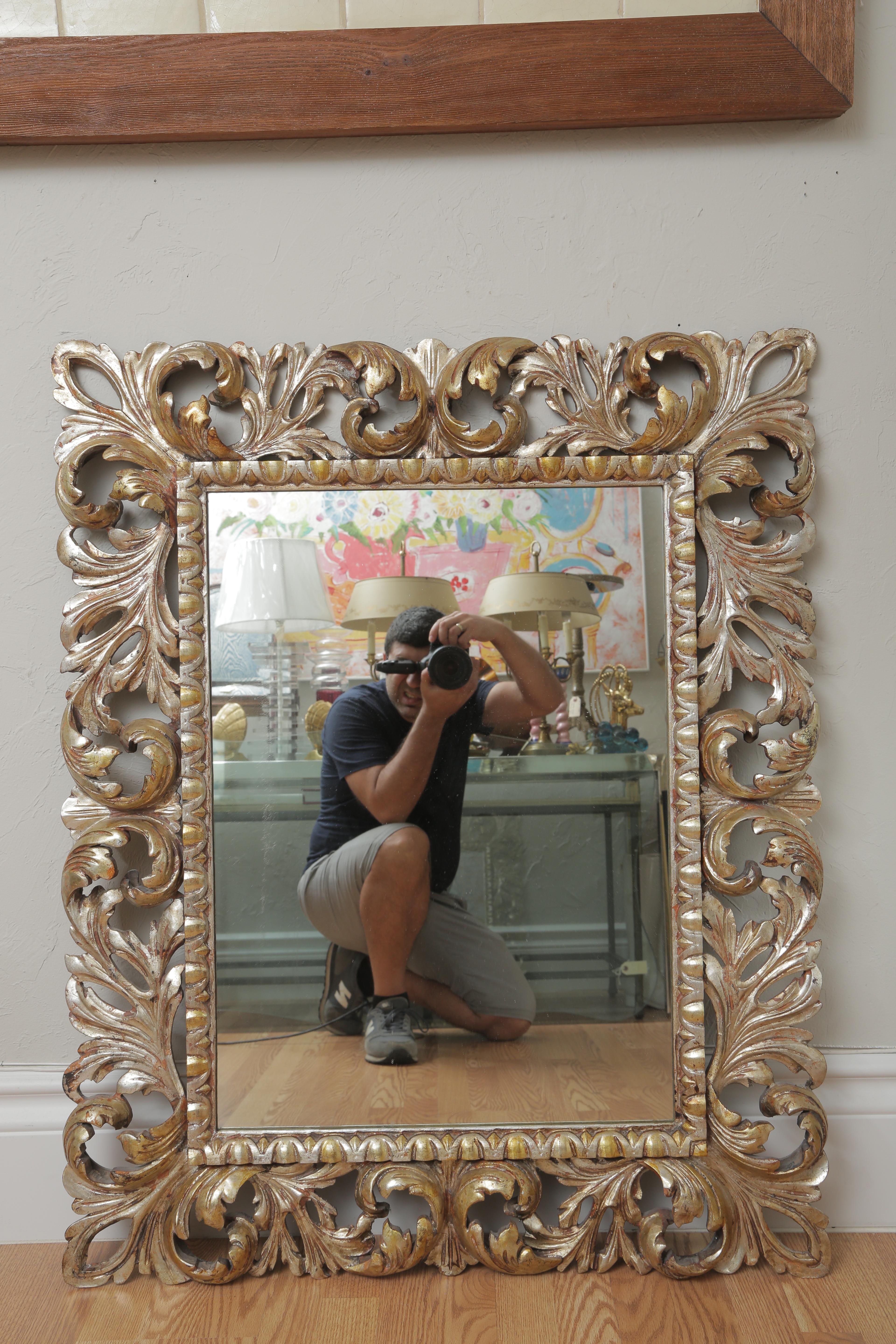 Gilded gold and silver carved wood Italian Rococo wall mirror.