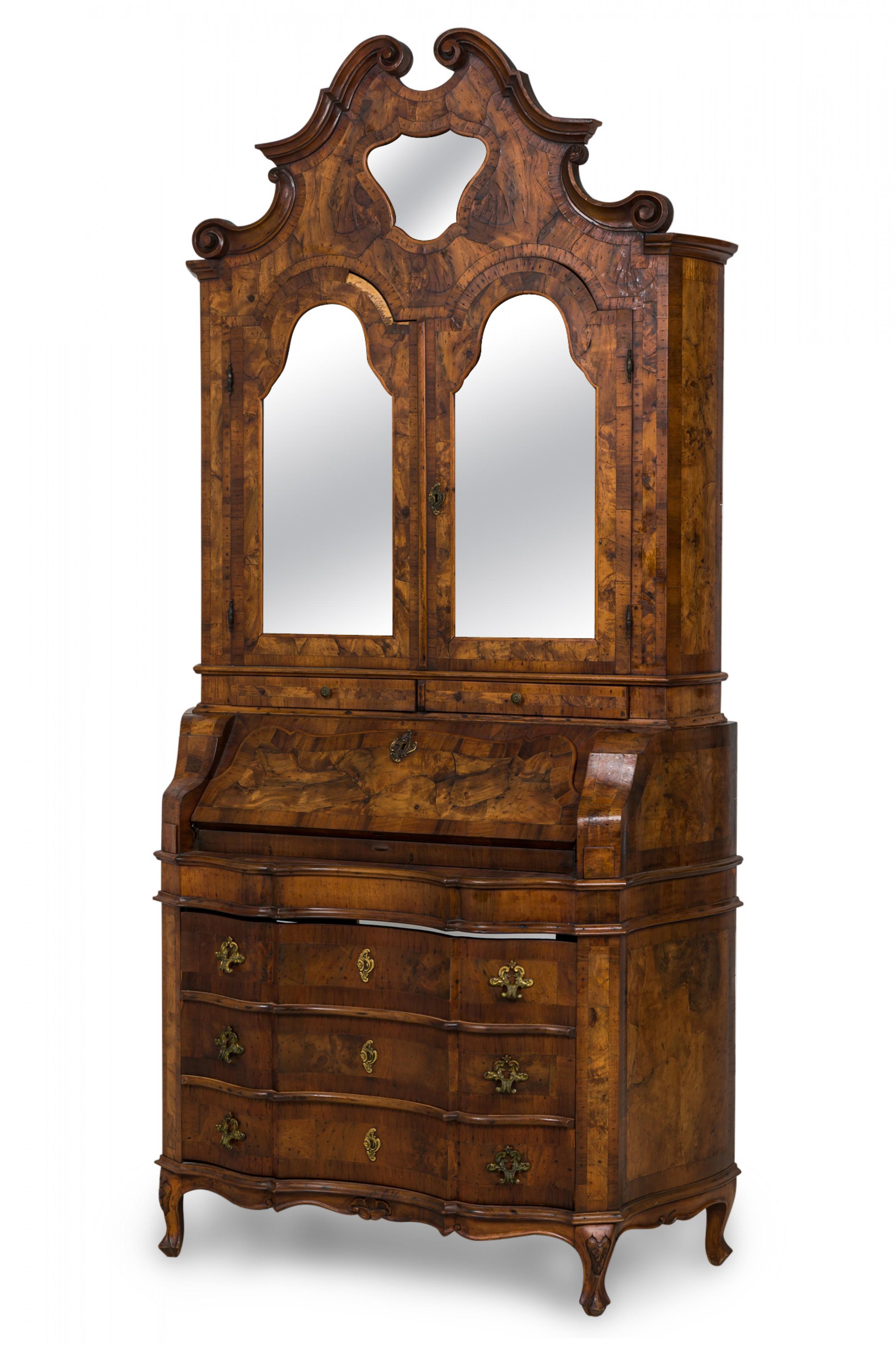 Italian Rococo secretary desk / cabinet with an upper door that folds down to reveal a writing surface and 5 small interior drawers, over three drawers with serpentine fronts and ornate brass drawer pulls, finished in an oyster burl veneer and