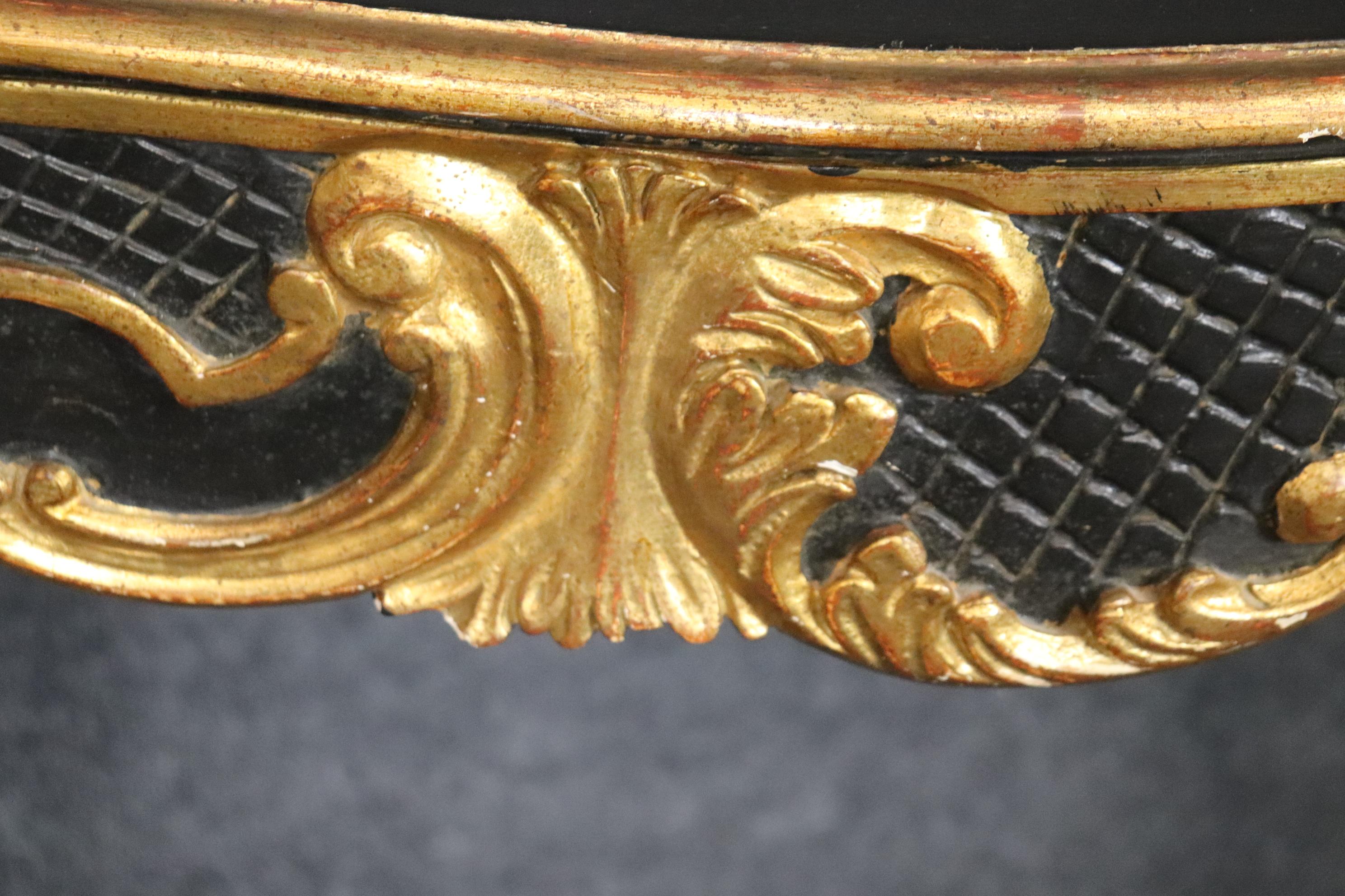 This is a gorgeous black and gold leaf Italian-made Rococo style console in the LOuis XV style. The table is in good condition and has minor signs of wear to teh gold and painted finish from age. The table has beautiful carving and exceptional