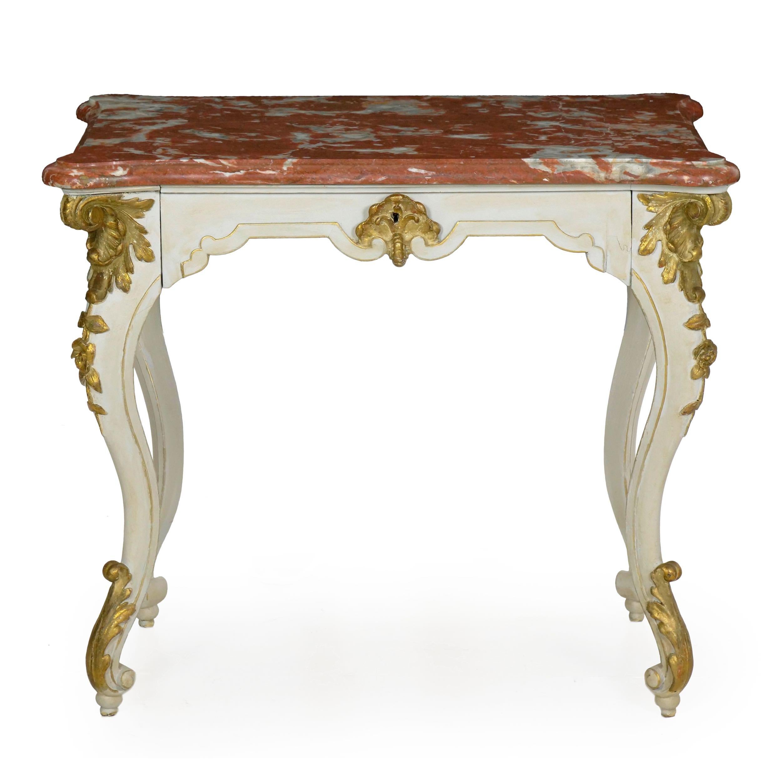 A playful piece full of life and movement, this gorgeous console table has great personality in its exaggerated form. The thick rouge marble top is beautifully curved to conform to the table, the corners with large turrets, 19th century.

Influenced