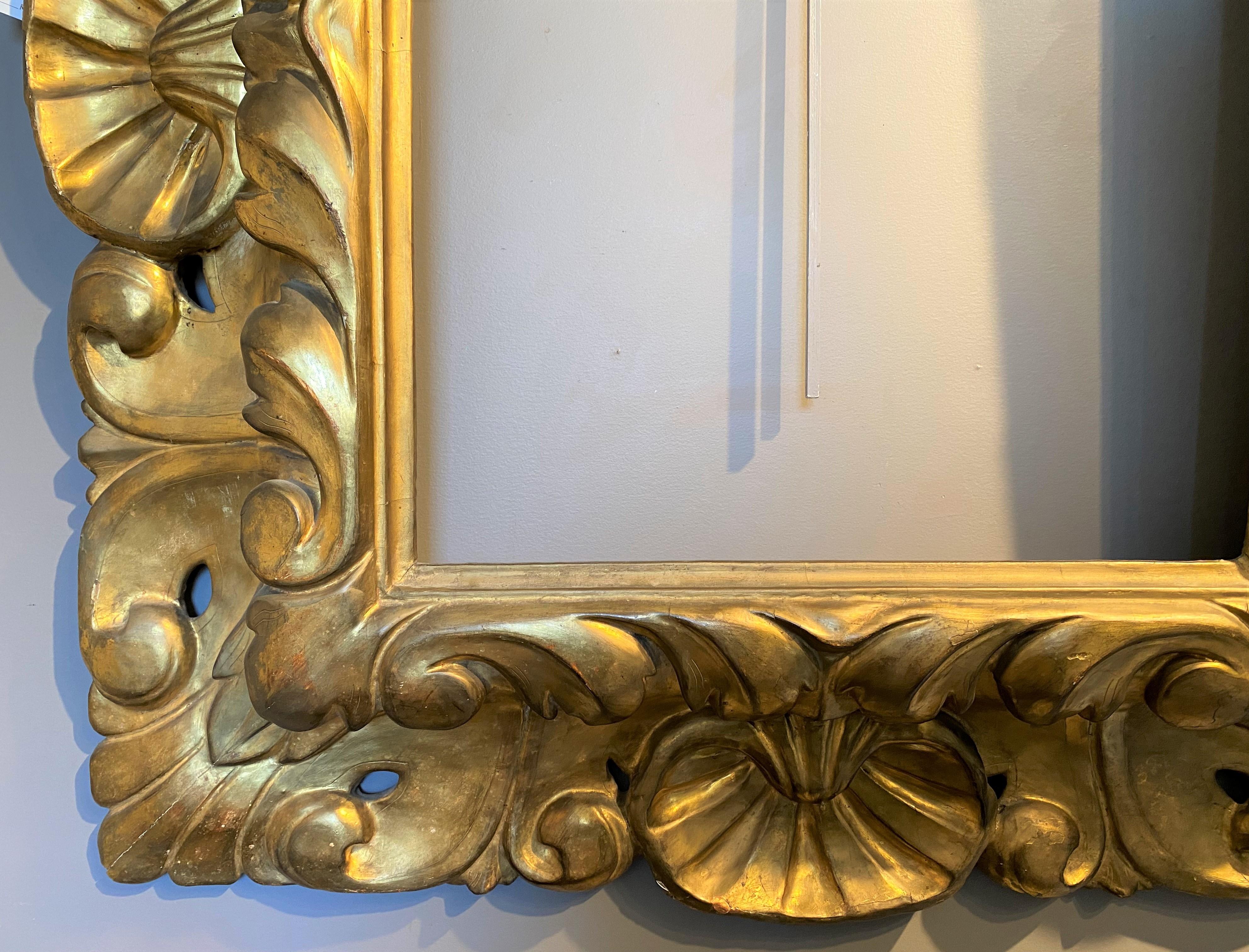 18th Century Italian Rococo Pierce Carved Giltwood Frame with Shell Decoration For Sale