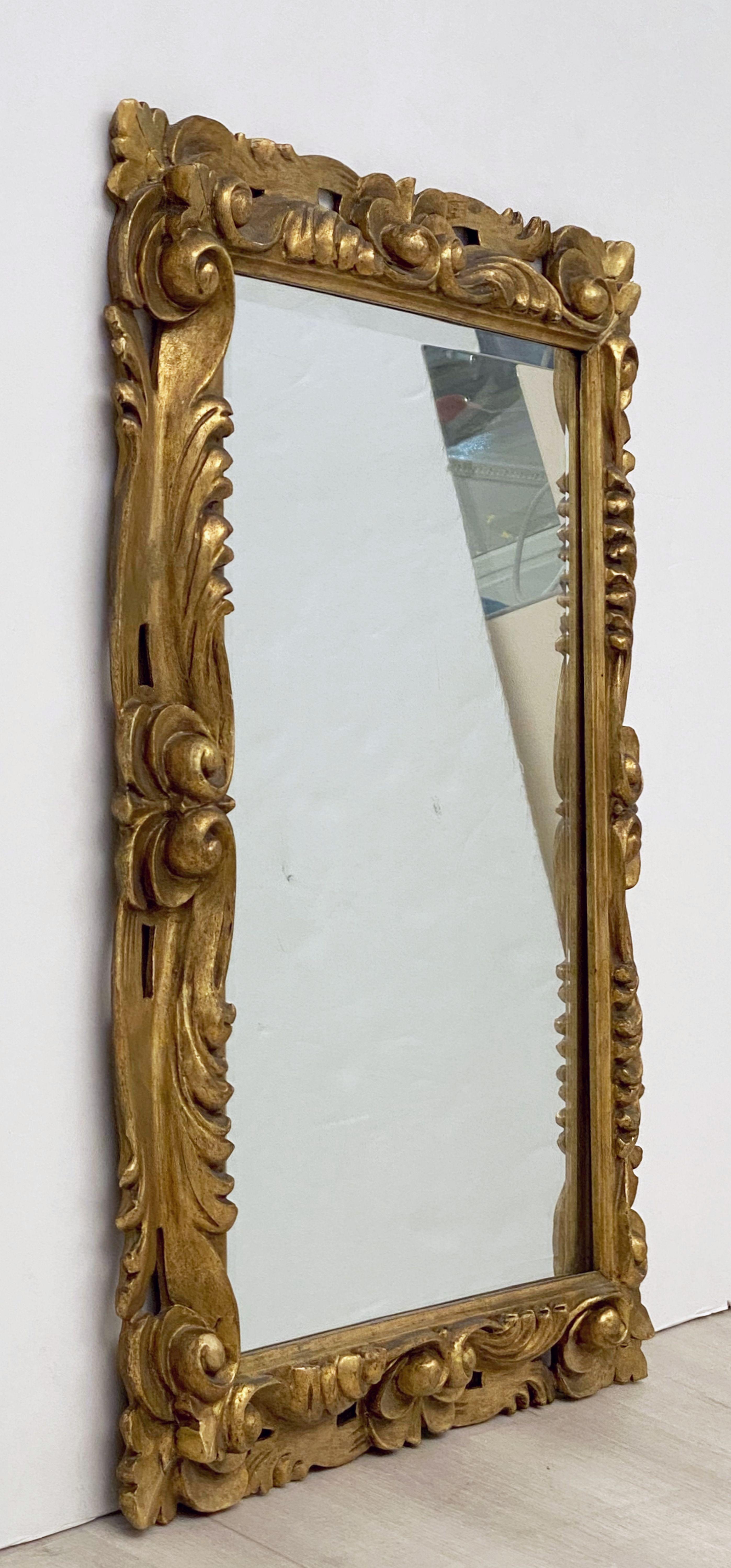 A fine Italian rectangular beveled mirror with a carved giltwood frame in the Rococo style.

Dimensions are H 29 inches x W 23 inches

Can be displayed vertically or horizontally.