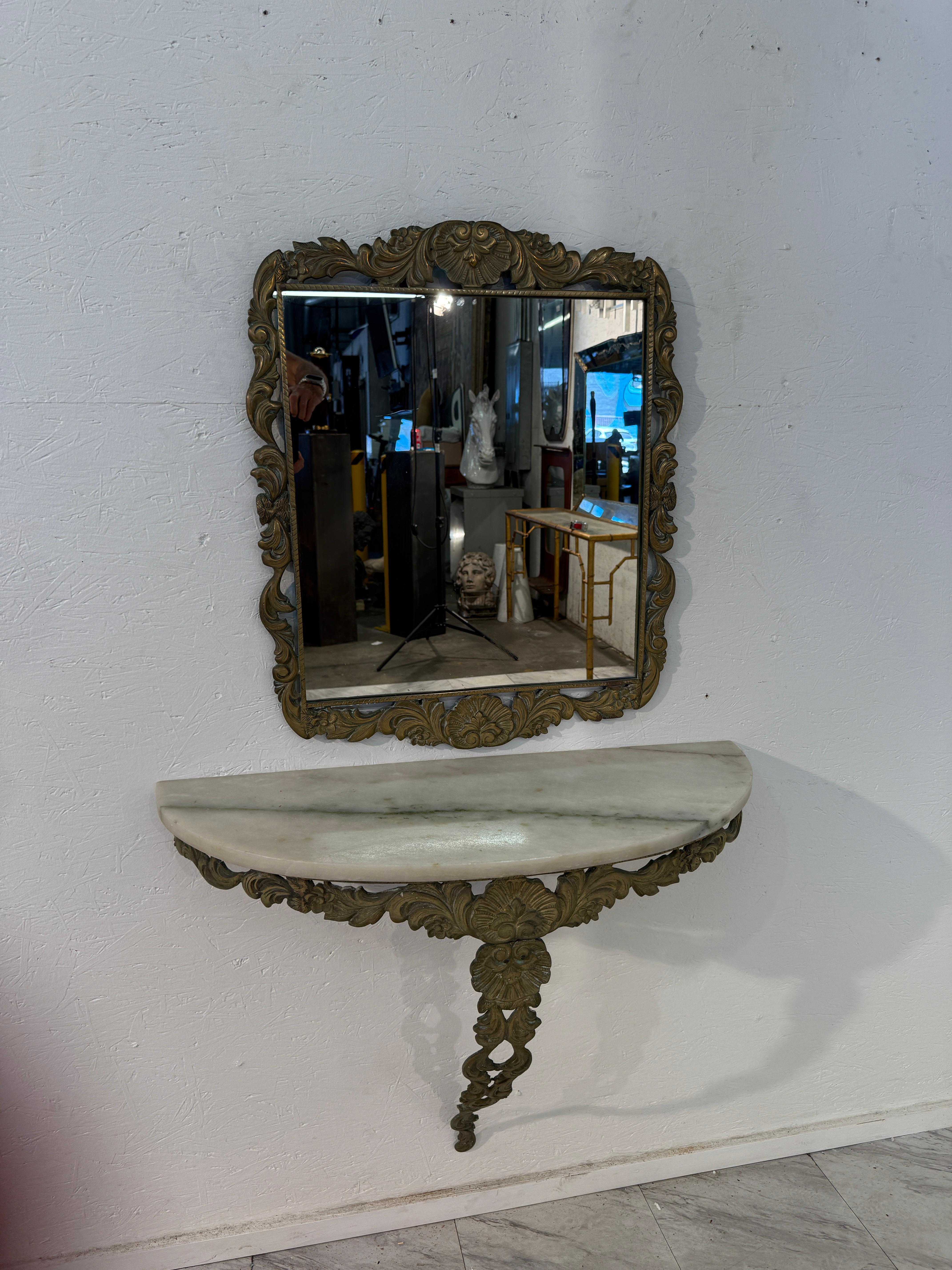 Italian mirror and console set from the 1950s, crafted in the Rococo Revival style. The mirror features an ornate gilt frame richly decorated with scrolling acanthus leaves and floral motifs, perfectly complementing the console below. The