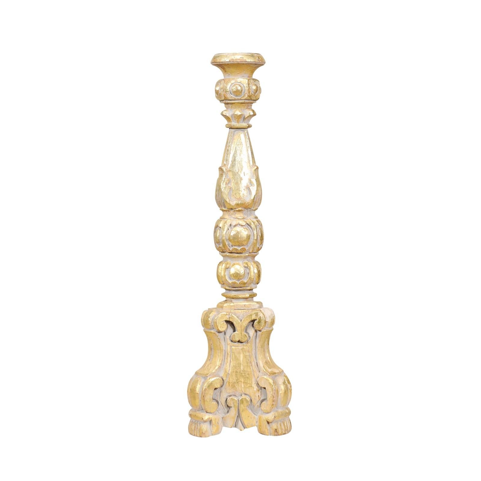 An Italian Rococo style giltwood candlestick from circa 1890 with carved scrolling décor. This Italian Rococo-style giltwood candlestick, dating back to circa 1890, exudes opulence and elegance. Its ornate design is a testament to the craftsmanship