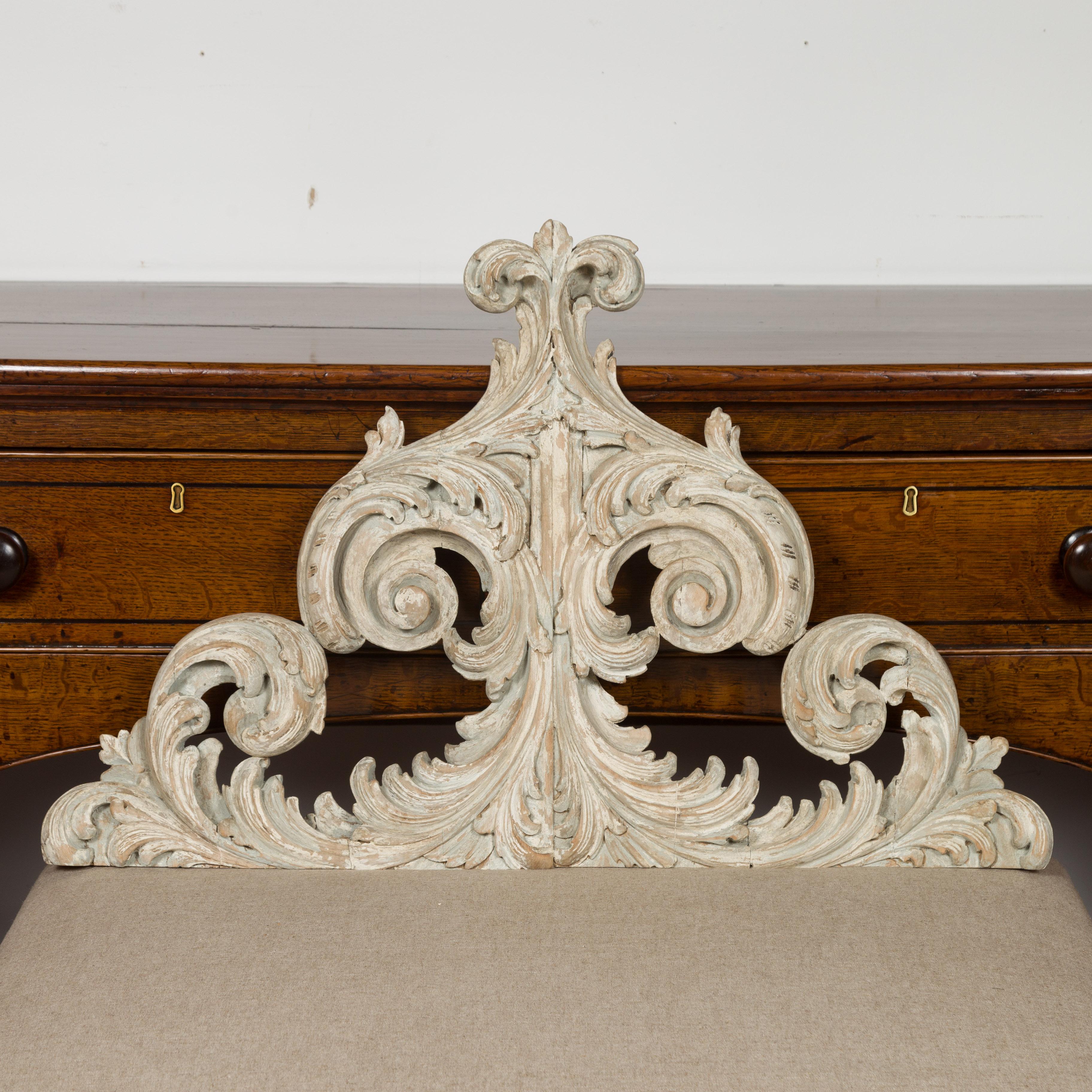 An Italian Rococo style painted wood architectural fragment from the late 19th century, with carved acanthus leaves, volutes and distressed finish. Created in Italy during the later years of the 19th century, this architectural fragment attracts our