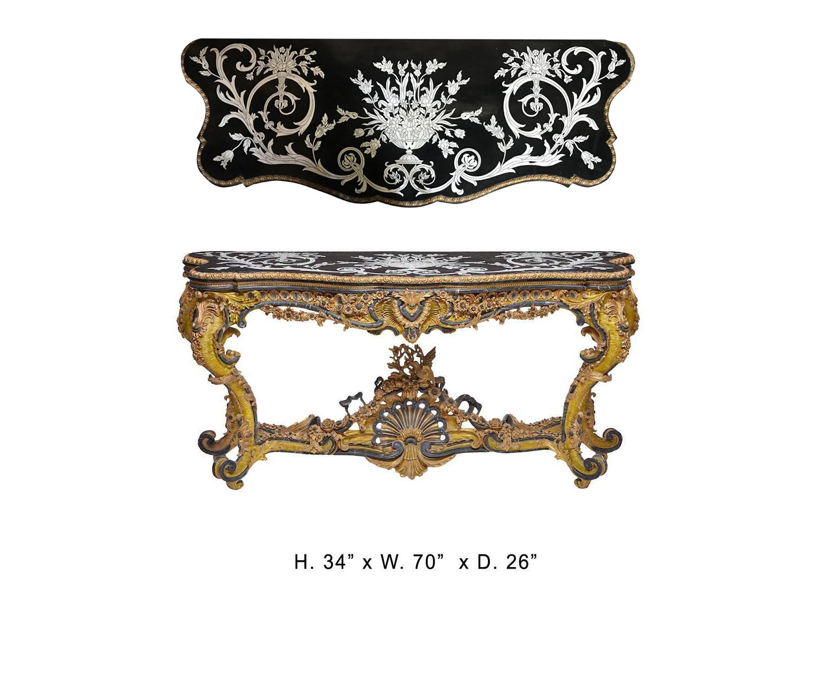 Highly impressive Italian Rococo style carved marble and gilt composition console with inlaid and veneered marble top,
late 20th century.
The black serpentine-fronted marble top is veneered and inlaid in a decorative scrolling foliage motif