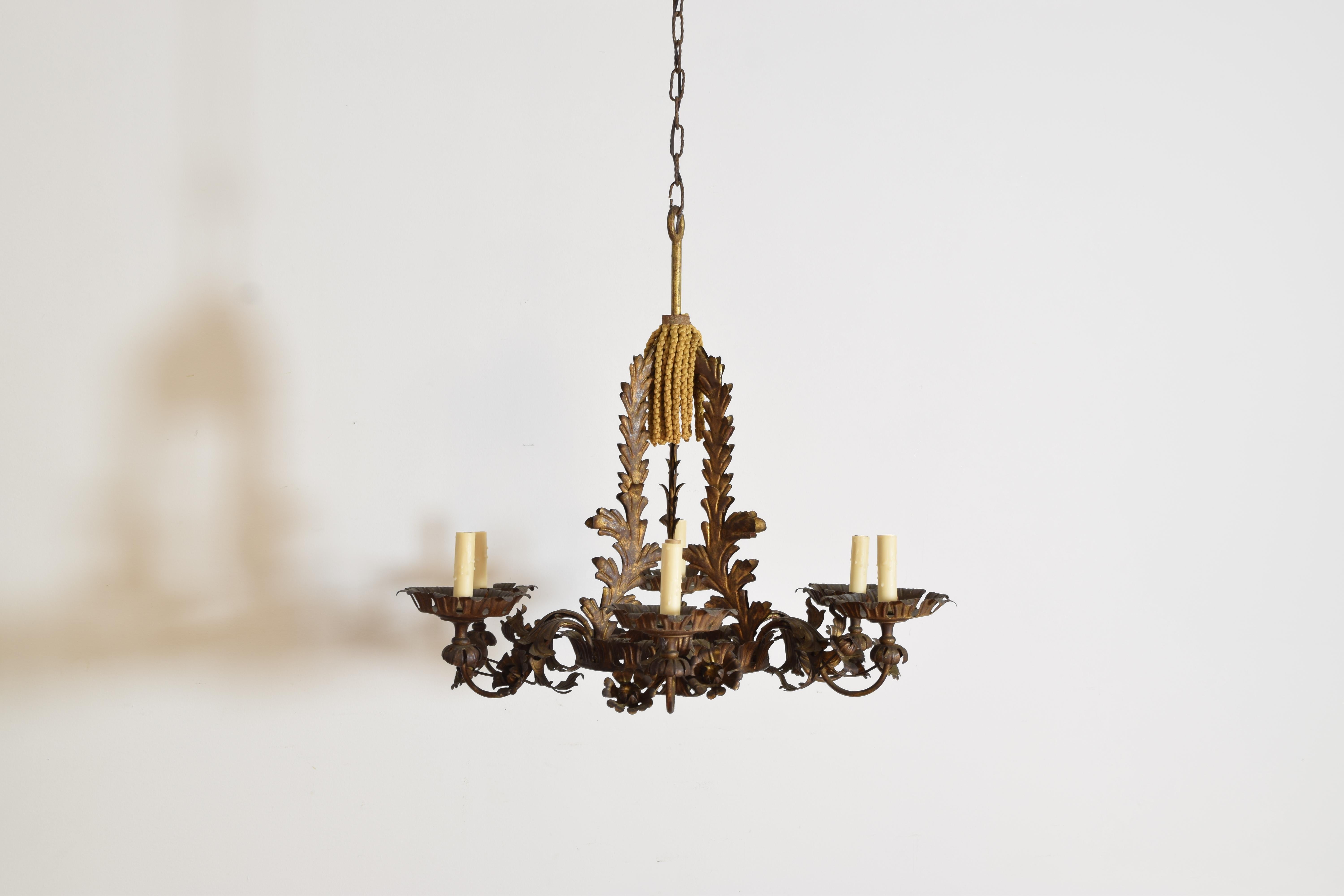 constructed entirely of gilded metal and comprised of scrollwork of various forms, the bobeches crown-shaped, now rewired