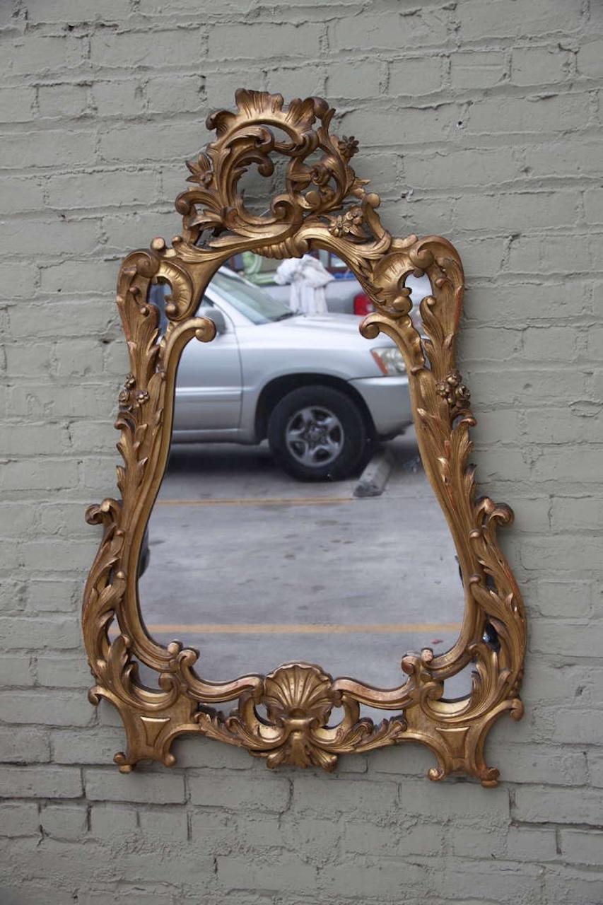 19th century carved giltwood Rococo style mirror with acanthus leaves and carved shell design.