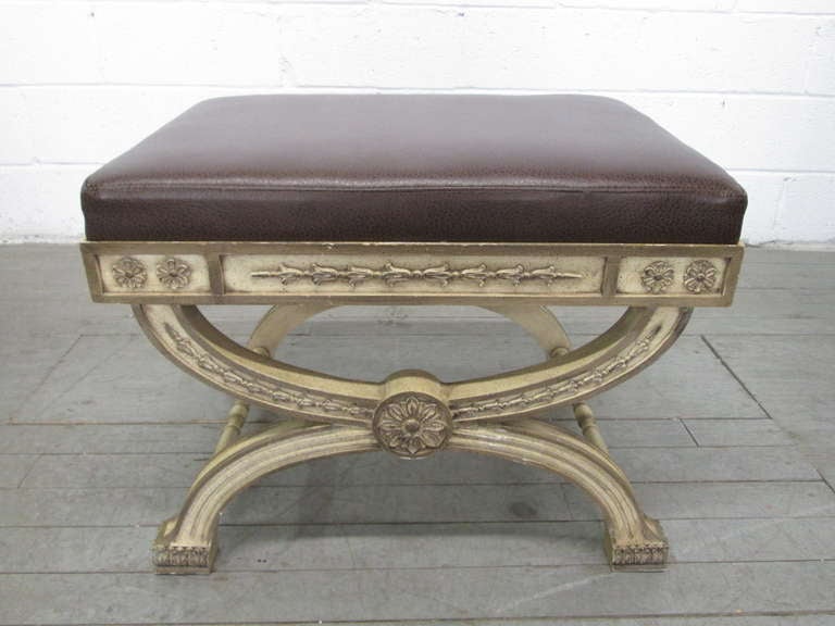 Rococo style wood carved painted bench with brown vinyl seat.