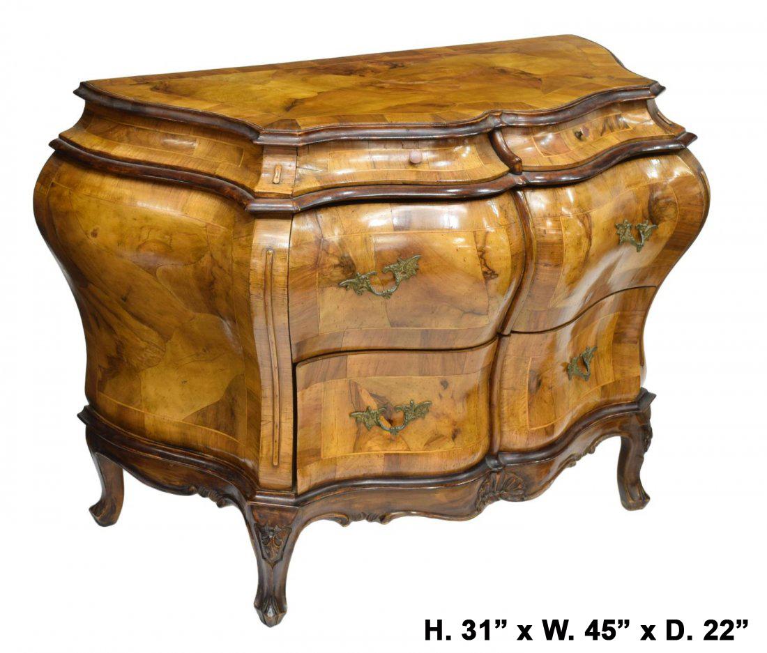 Attractive Italian Rococo style walnut Bombe commode.
Mid 20th century. 
A moulded walnut veneered top rests over two small and four larger walnut veneered drawers, mounted with foliate-inspired bronze handles, above a shaped apron centered with a
