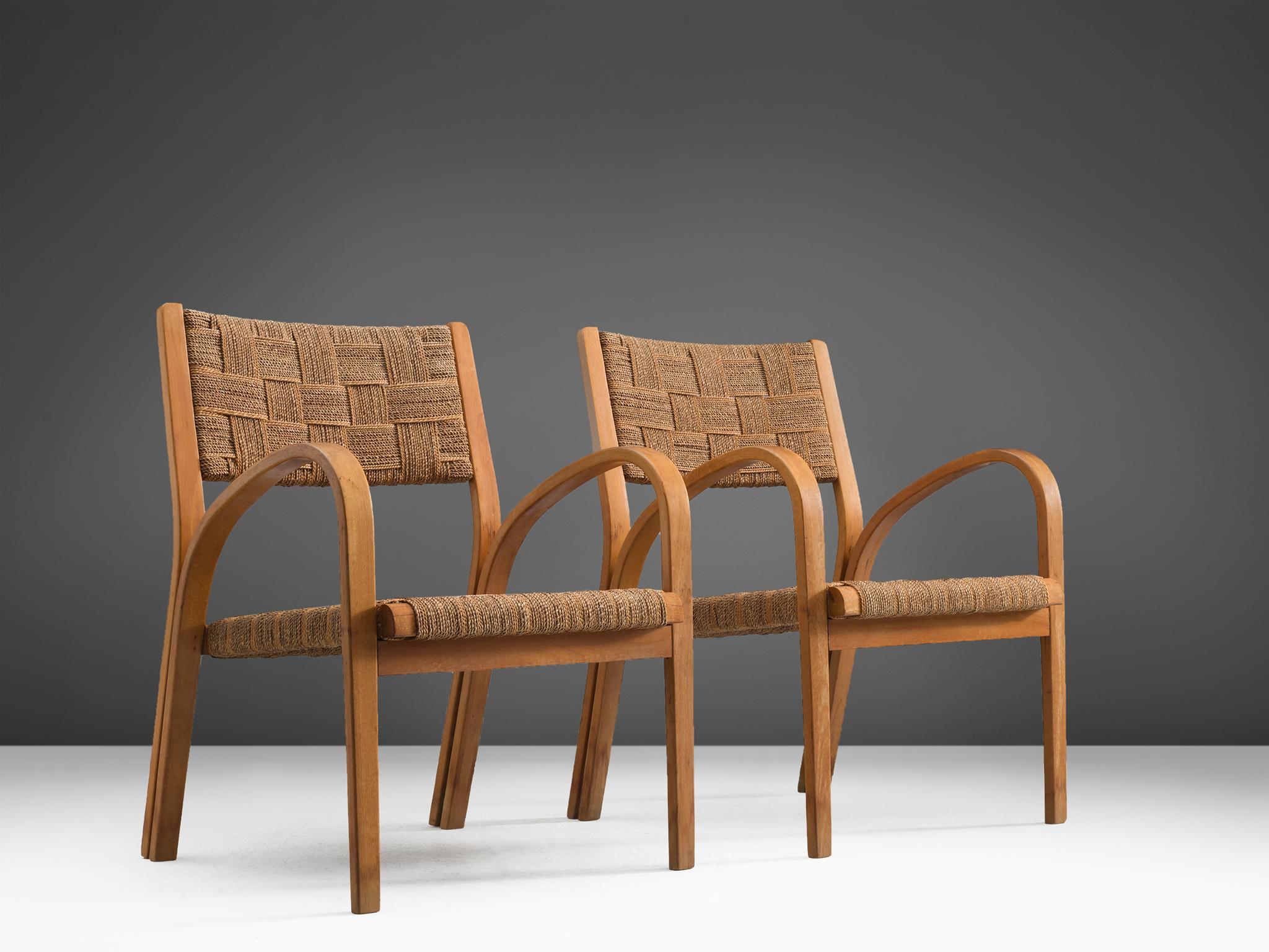 Armchairs with ottomans attributed to Giuseppe Pagano, curved wooden structure coated rope, Italy, 1940s.

These lounge chairs are executed in wood and coated rope. The design of this set of chairs is Minimalist yet not in a Puritan way. The