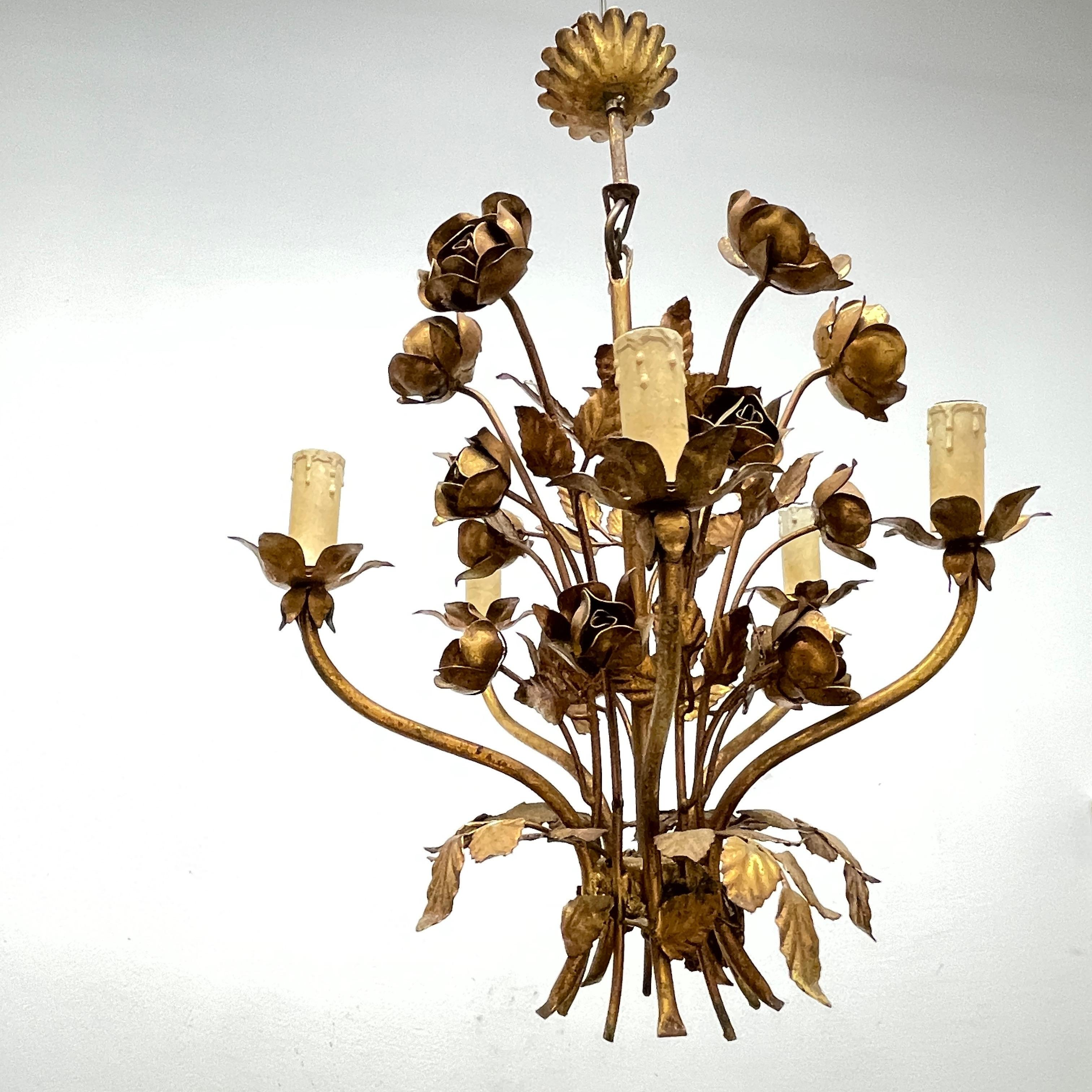 A Hollywood Regency midcentury gilt tole roses chandelier, the fixture requires five European E14 candelabra bulbs, each bulb up to 40 watts. This light has a beautiful patina and gives each room an eclectic statement.