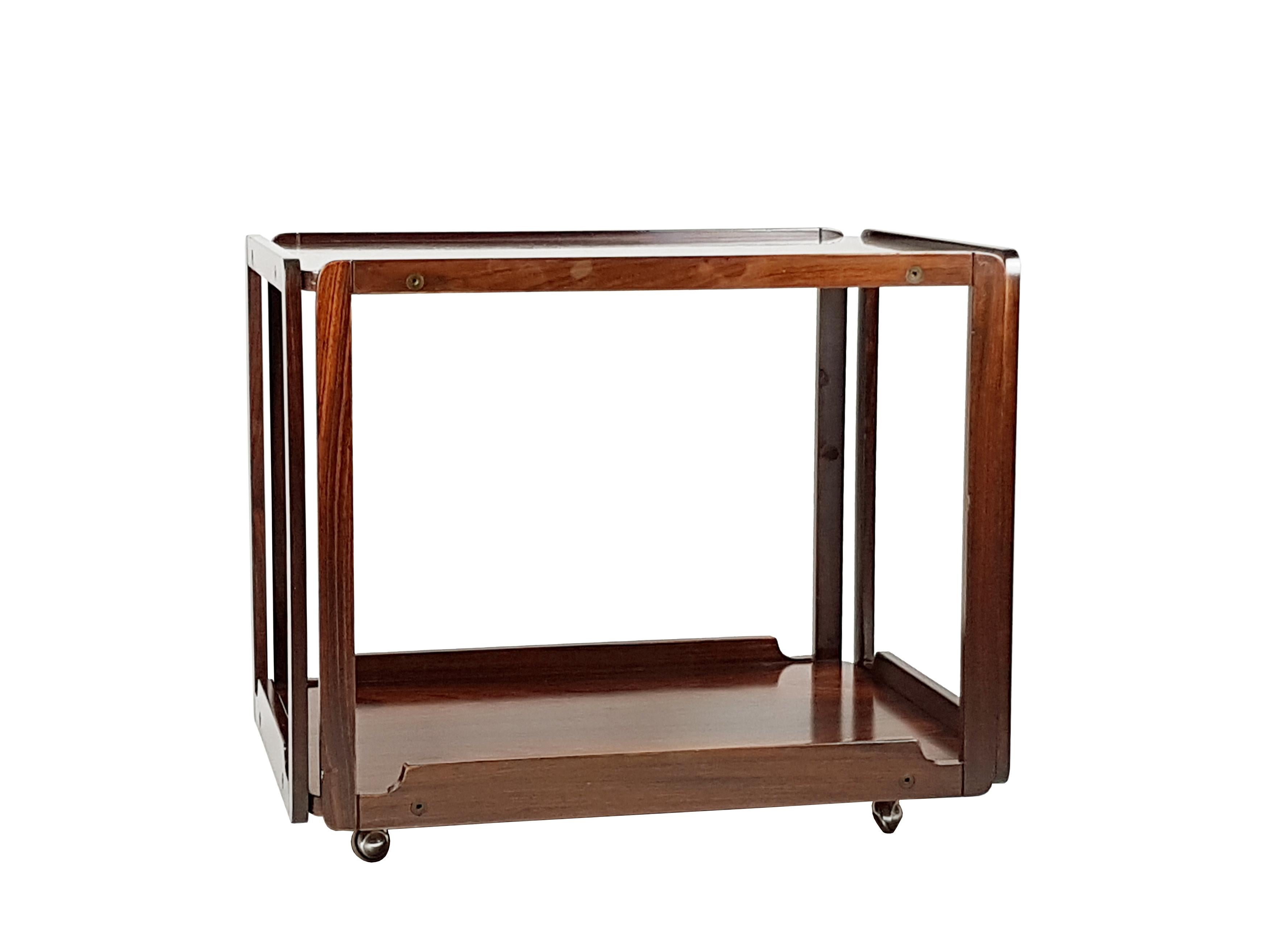 Rosewood serving cart produced in Italy, circa 1965 and attributed to Bernini. It features 2 serving trays and 4 metal wheels.