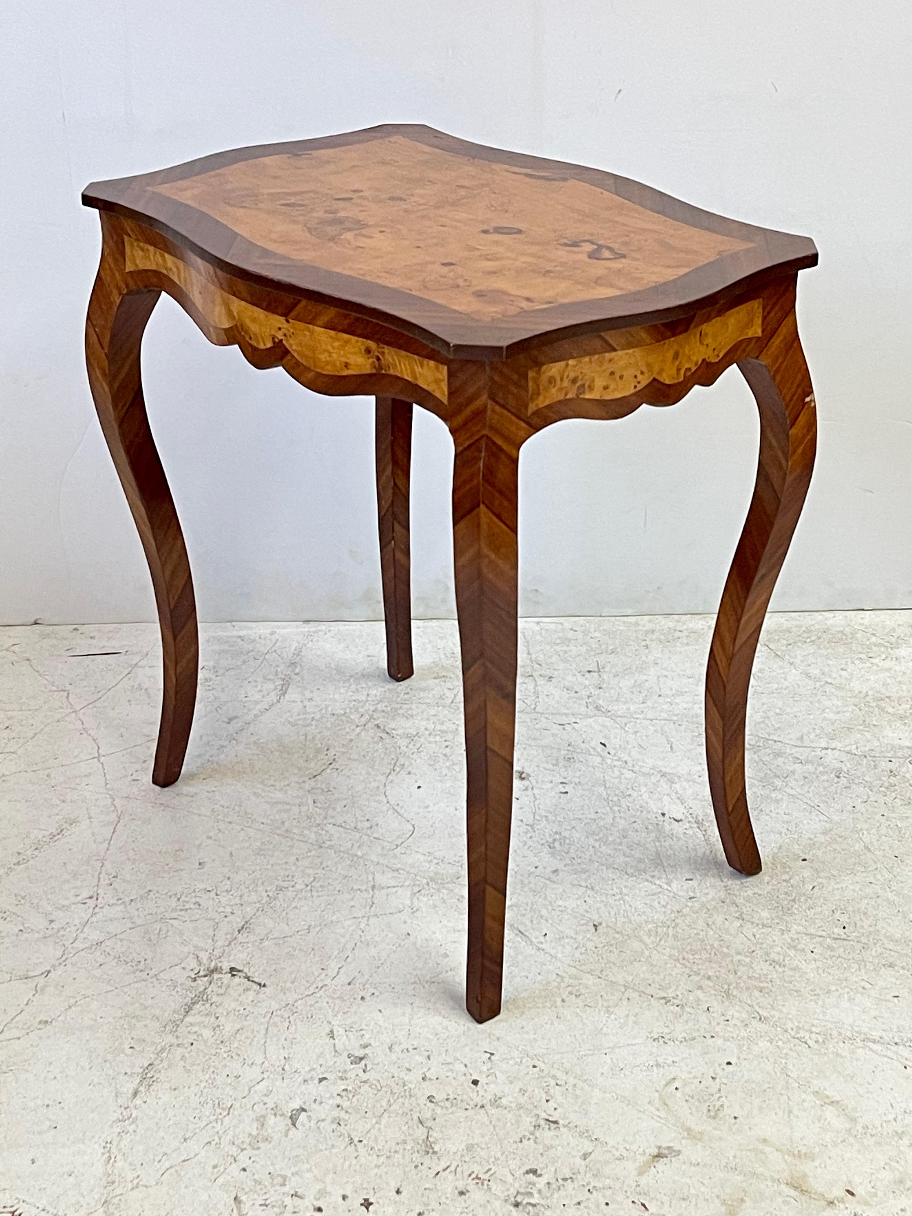20th Century Italian side table beautifully made of burlwood and rosewood veneers in the style of Louis XV. The symmetrical rectangular table has a shaped top with canted corners over a serpentine frieze with scalloped apron on all sides. The table