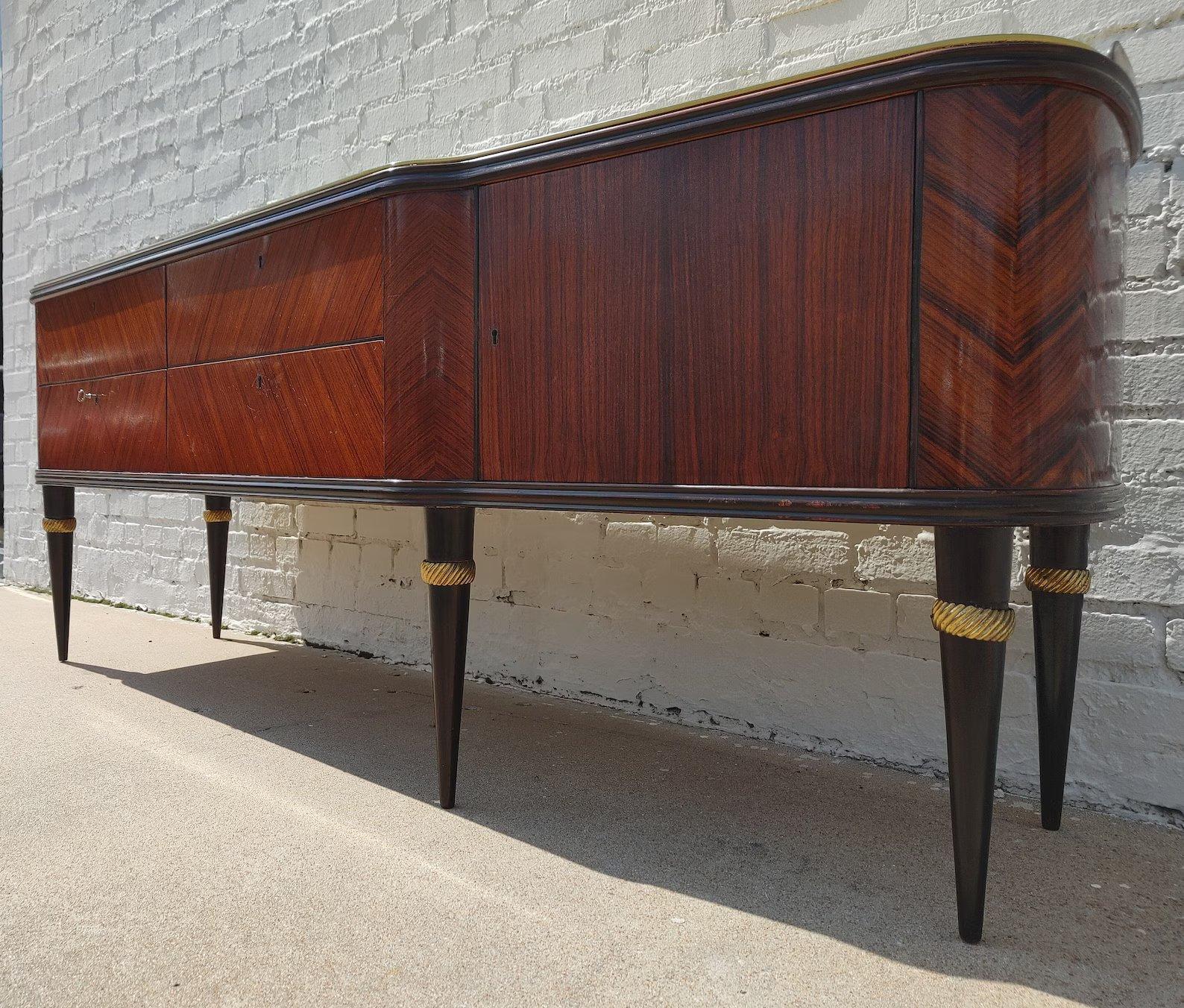 Italian Rosewood Herringbone Credenza

Above average vintage condition and structurally sound. Has some expected finish wear and scratching. Right door has some lacquer wear which is somewhat visible in the listing pictures. Please request